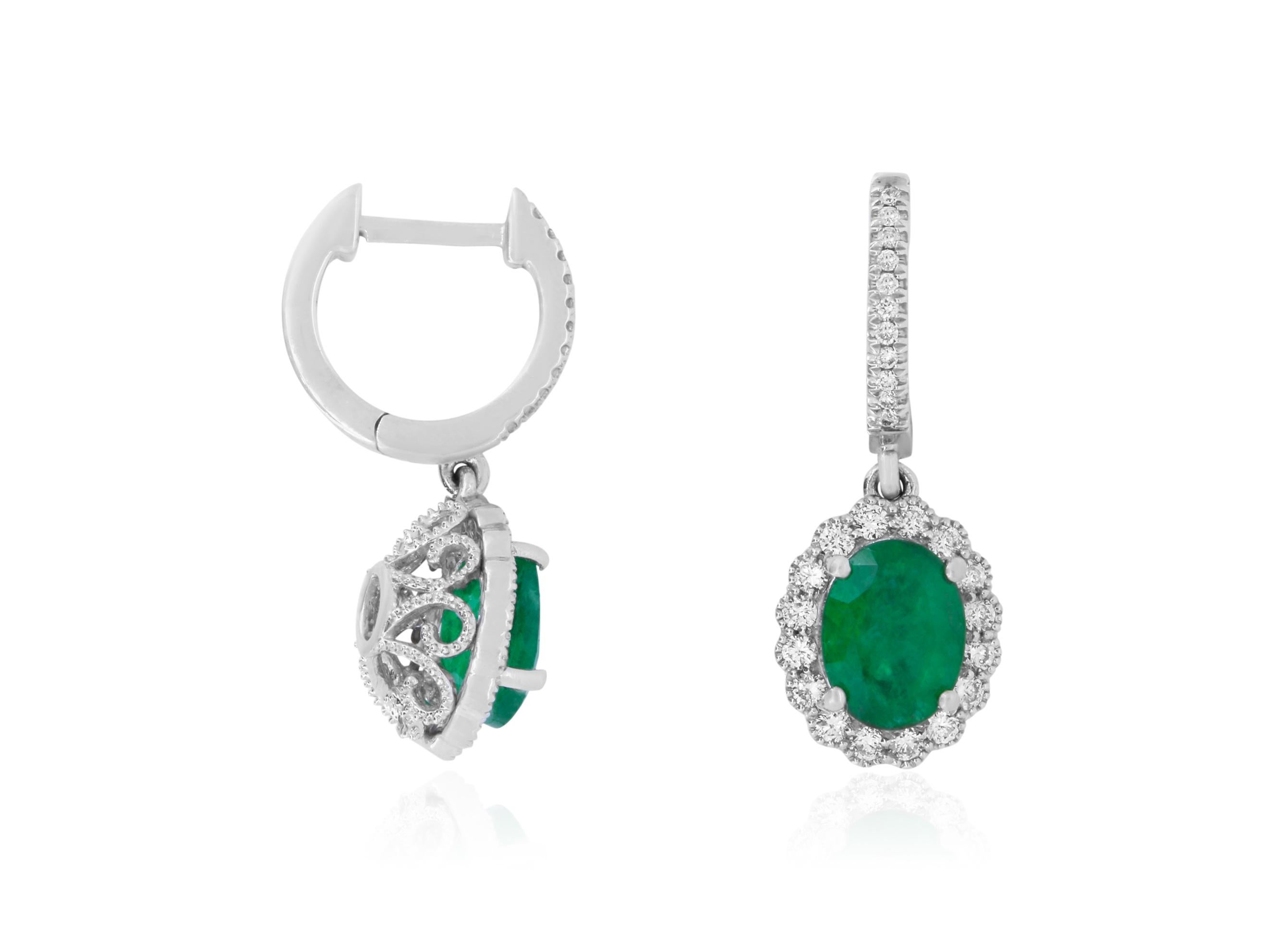 Material: 18k White Gold 
Stone Details: 2 Oval Shaped Emeralds at 2.37 Carats Total
Mounting Stone Details: 54 Brilliant Round White Diamonds at 0.55 Carats- Clarity: SI / Color: H-I

Fine one-of-a-kind craftsmanship meets incredible quality in