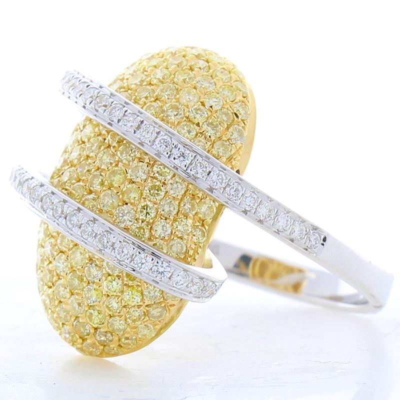 This ring is breathtaking and bold! 2.02 carats of natural fancy yellow diamonds are paved in rich yellow gold. The back of the center piece is open for optimal light performance. White diamonds wrap around the yellows in an organic way. The bright
