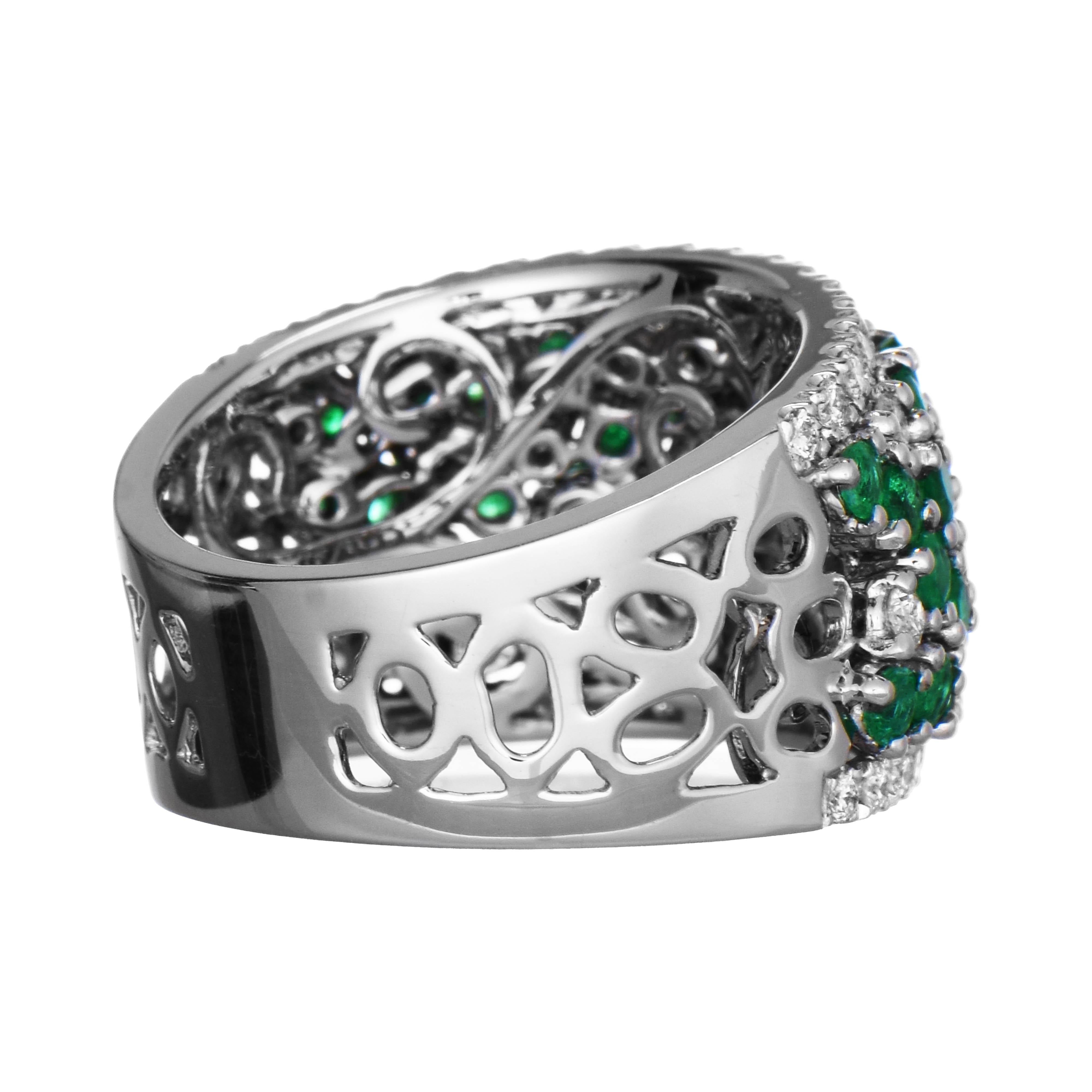 This luxurious dome ring features an intricate design showcasing vibrant emeralds and sparkling white diamonds, bordered by rows of white diamonds, all set in white gold.

46 Emerald Gemstones: 1.74 Carats, Round Cut
47 White Diamonds: 0.63 Carat,