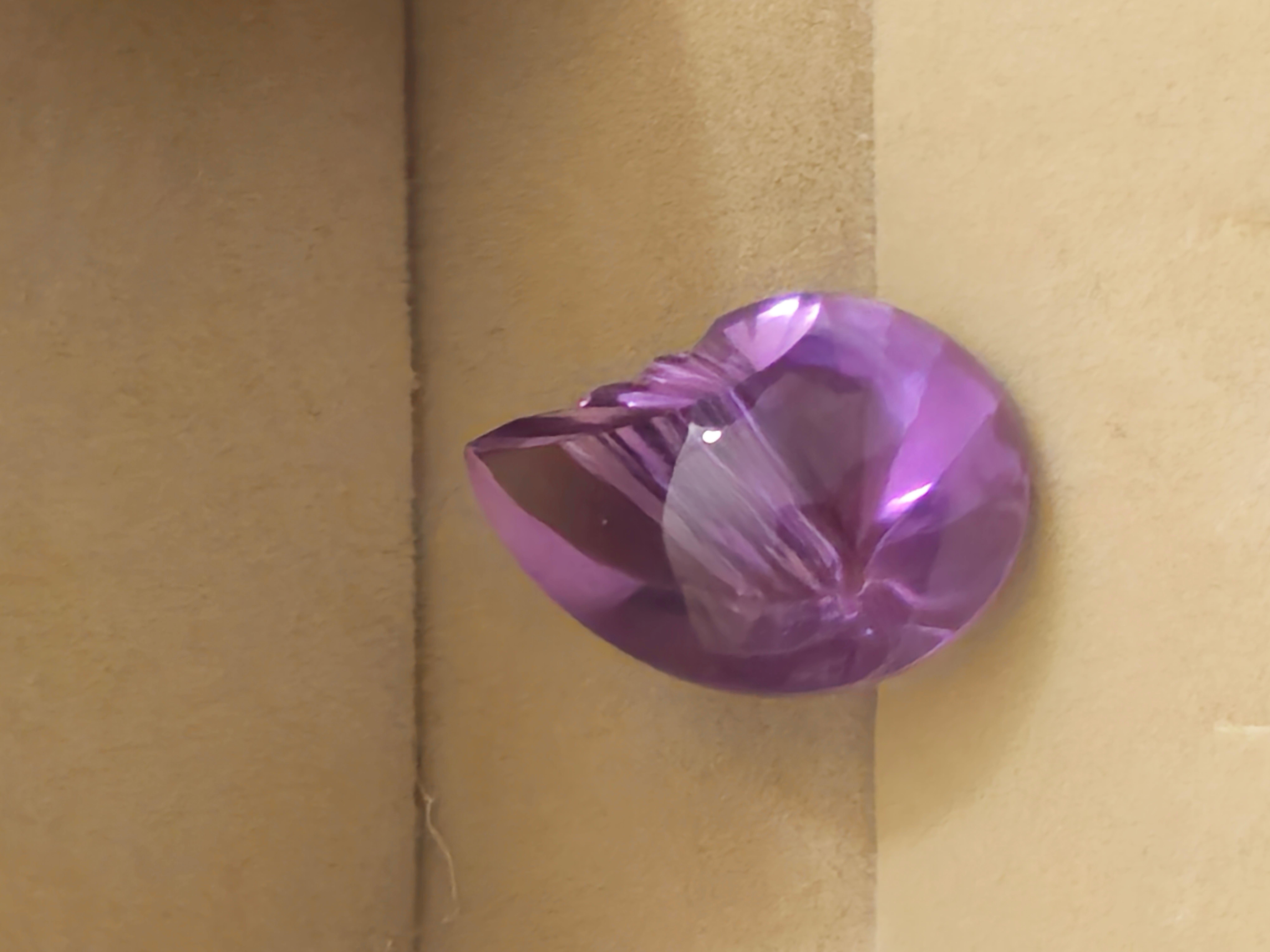 This beautiful 23.7 ct. Amethyst Gemstone is perfect for those who appreciate the beauty of natural stones. The Fantasy Cut shape of this Loose Gemstone is a unique and elegant way to add a touch of sophistication to any jewelry piece. This Gemstone
