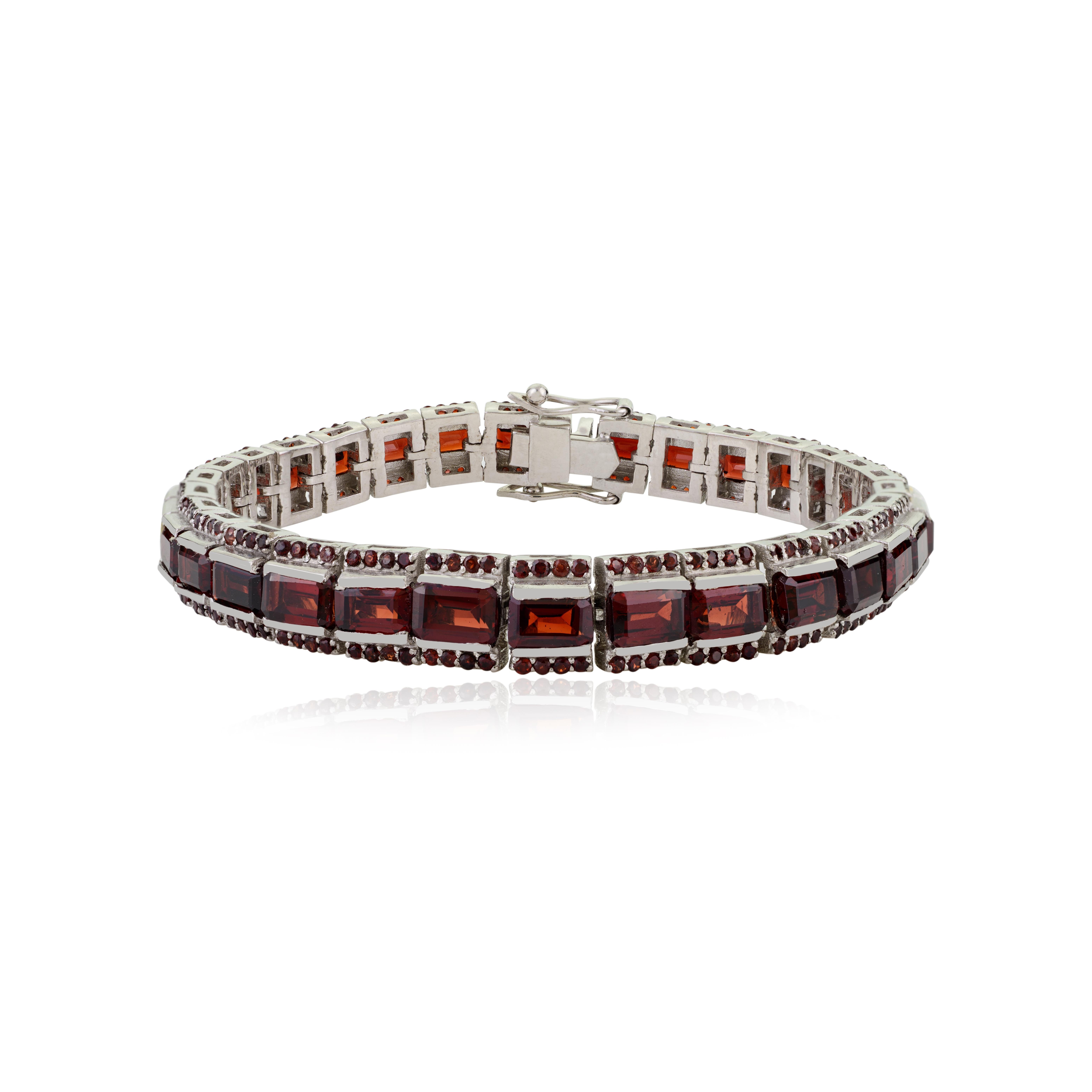 This lovely tennis bracelet is made with 925 sterling silver and features deep red garnet gemstones that shine beautifully. It has two rows of sparkling stones—some are shaped like octagons (6x3 mm), and others are small round stones (1.2