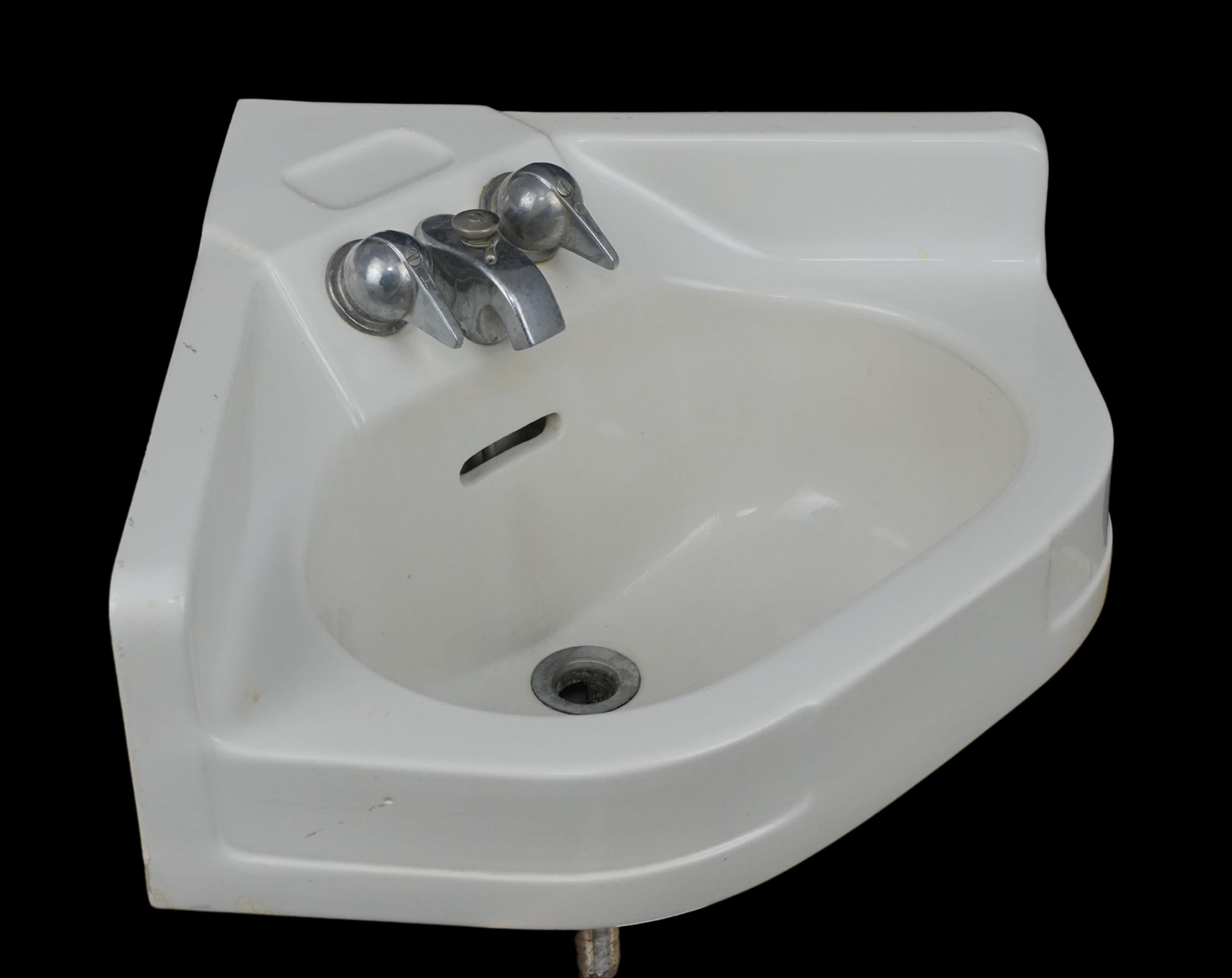 20th Century Crane Cornate corner wall sink made of ceramic with a white porcelain finish. The original nickel hardware was also made by Crane. Good condition with normal wear and tear. One available. Please note, this item is located in our
