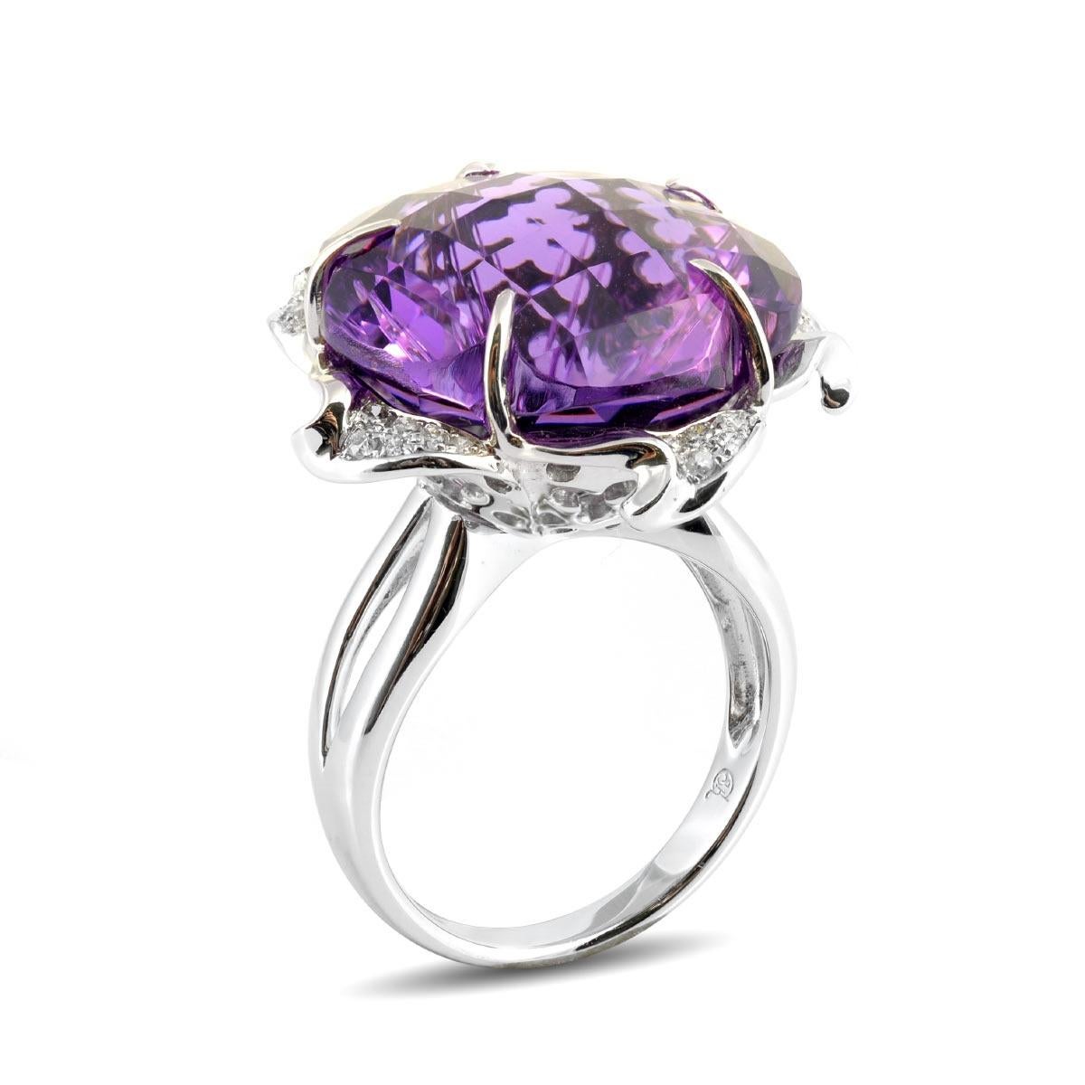 Introducing an exquisite ring adorned with a distinct checkerboard cut showcasing the deep and rich hues of aubergine Amethyst. The intricate cut mirrors the elegance of delicate petals, further accentuated by the embrace of diamonds set in 18K