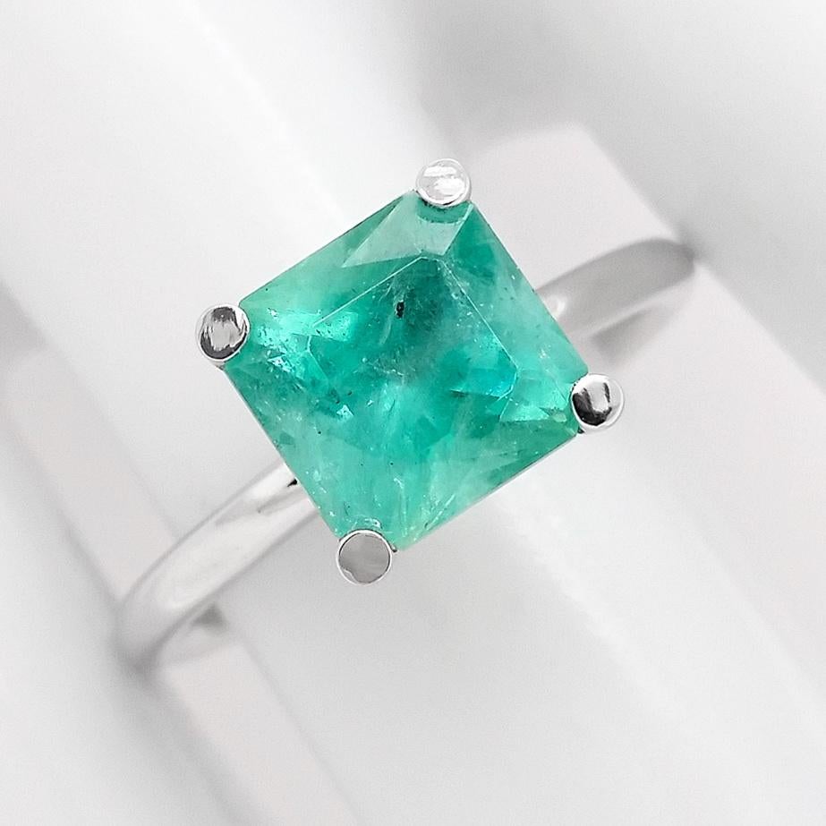 FOR U.S. BUYERS NO VAT

This simple but elegant, 14kt white gold ring features a square modified brilliant bluish green emerald with INDICATION OF MINOR CLARITY and weight of 2.66-carat. The amazing color combination of white and green within the