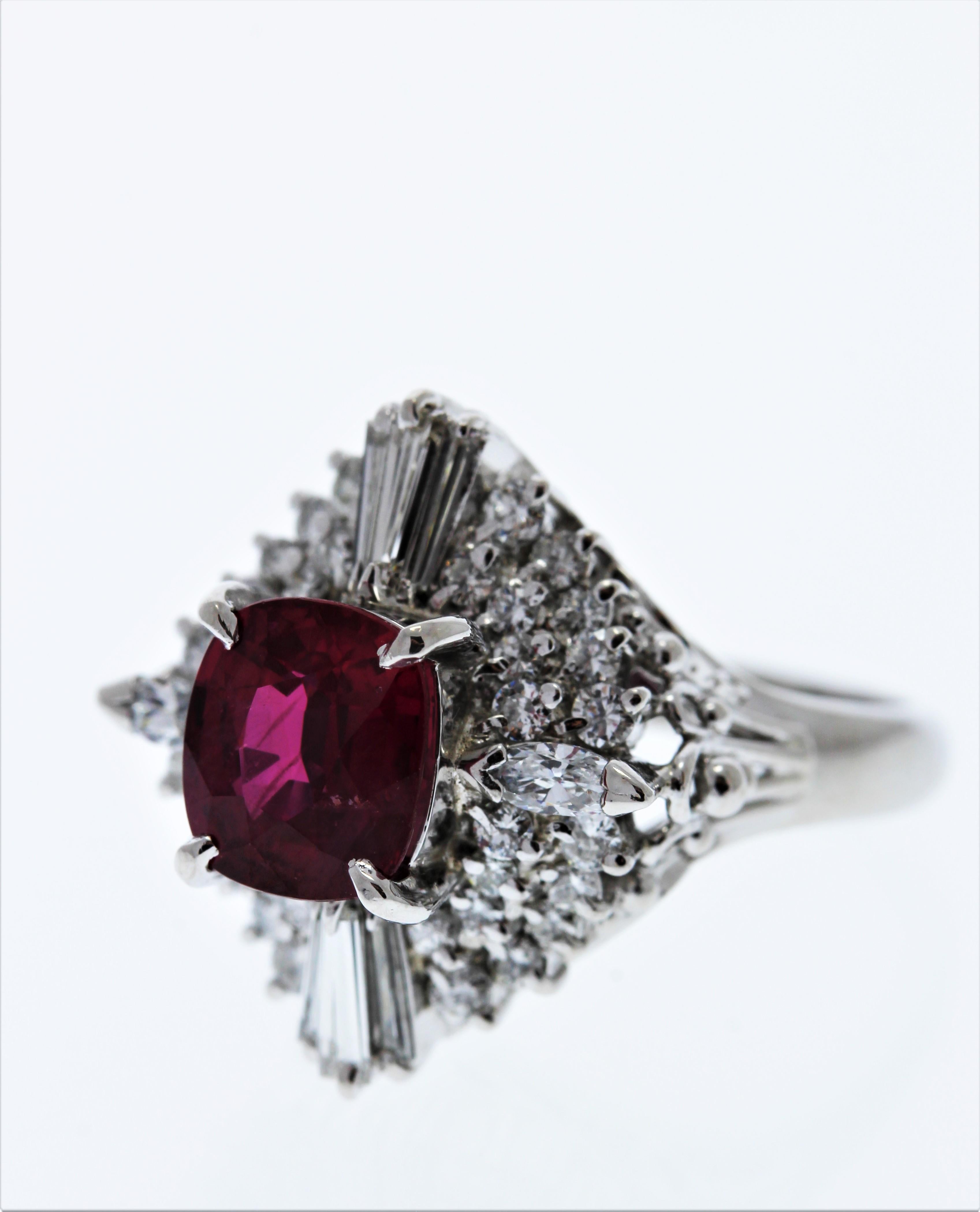 This is a gorgeous oval cut ruby. The gem source is Thailand. Its color is intense red; its transparency and luster are excellent. The shape is alluring; it has a fantastic length to width ratio. Surrounding the ruby is a halo of mixed cut diamonds