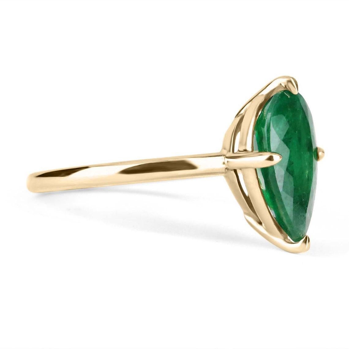 Displayed is a custom emerald solitaire pear-cut engagement/right-hand ring in 14K yellow gold. This gorgeous solitaire ring carries a 2.37-carat emerald in a four prong setting. The emerald has very good clarity with minor flaws that are normal in