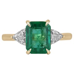 2.37tcw 18K Emerald Cut Emerald & Trillion Diamond Three Stone Ring