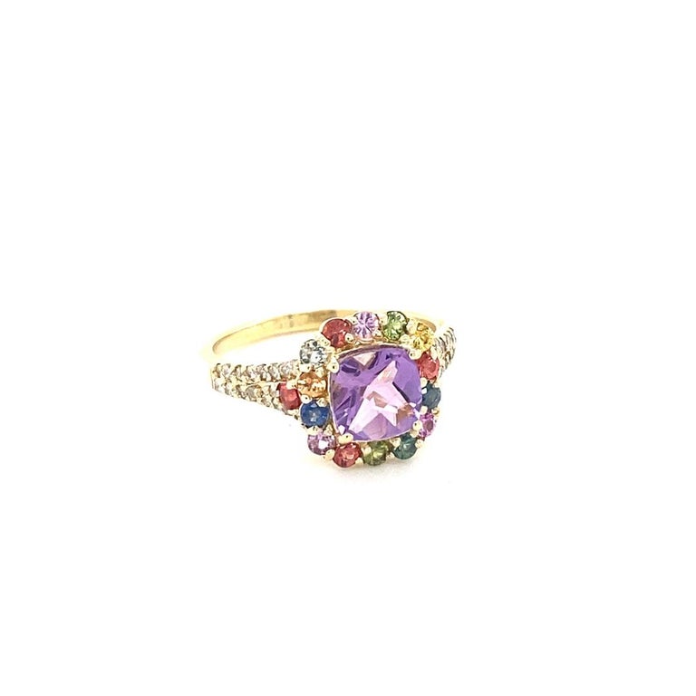 Beautiful 2.38 Carat Amethyst, Multi-Sapphire and Diamond Cocktail Ring! 

This uniquely designed Ring has a 1.25 carat Cushion Amethyst in the center of the ring which is surrounded by 16 Round Cut Multi-Colored Sapphires that weigh 0.80 carats. 