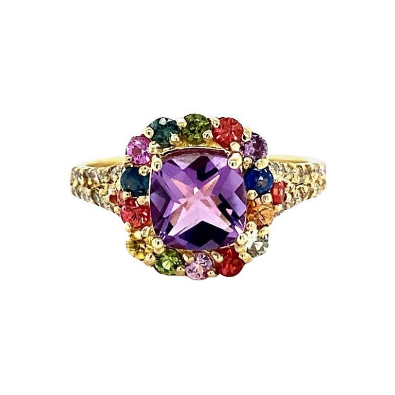 Beautiful 2.38 Carat Amethyst, Multi-Sapphire and Diamond Cocktail Ring! 

This uniquely designed Ring has a 1.25 carat Cushion Amethyst in the center of the ring which is surrounded by 16 Round Cut Multi-Colored Sapphires that weigh 0.80 carats. 