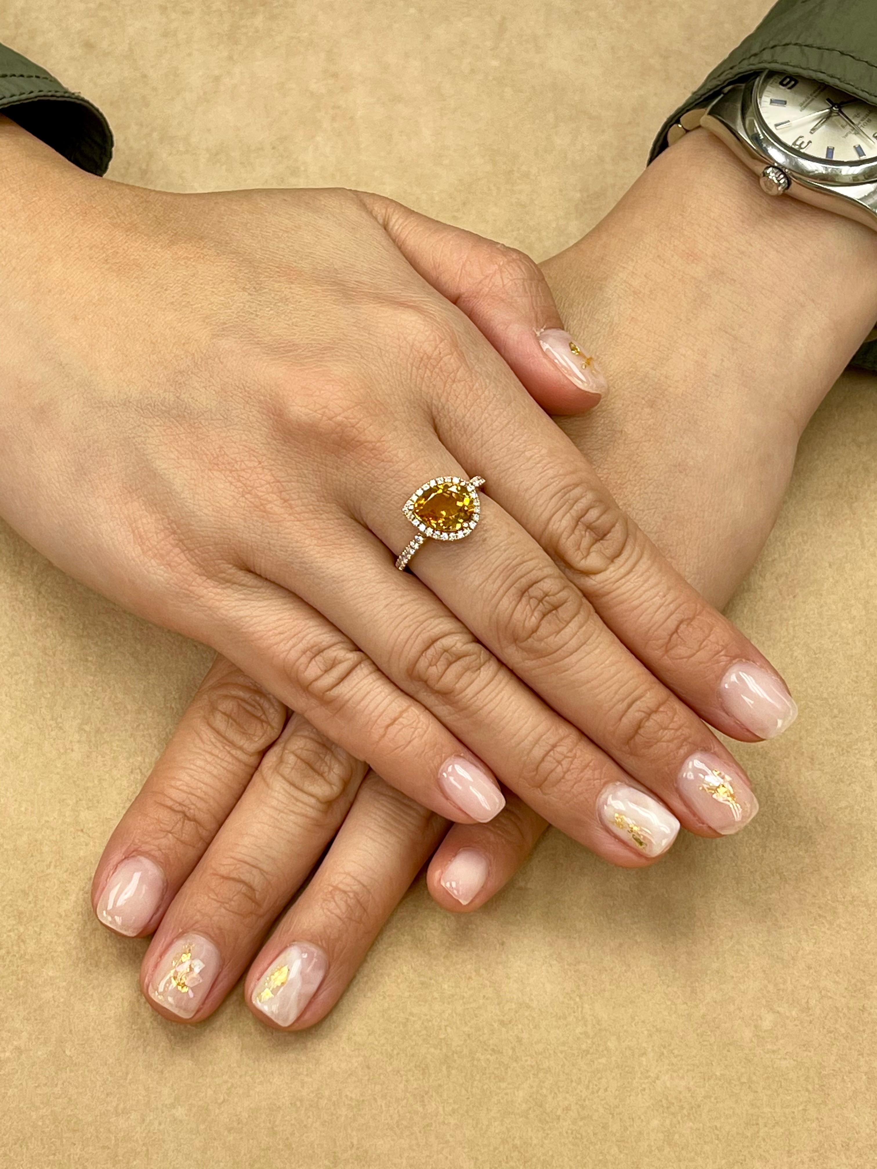 Here is a very elegant ring. Simple yet with an edge in design. The ring is set in 18k rose gold and diamonds. There are 0.32 Cts of white diamonds that make up this setting. The 2.38 Cts pear shaped Citrine is full of life. The color of the citrine