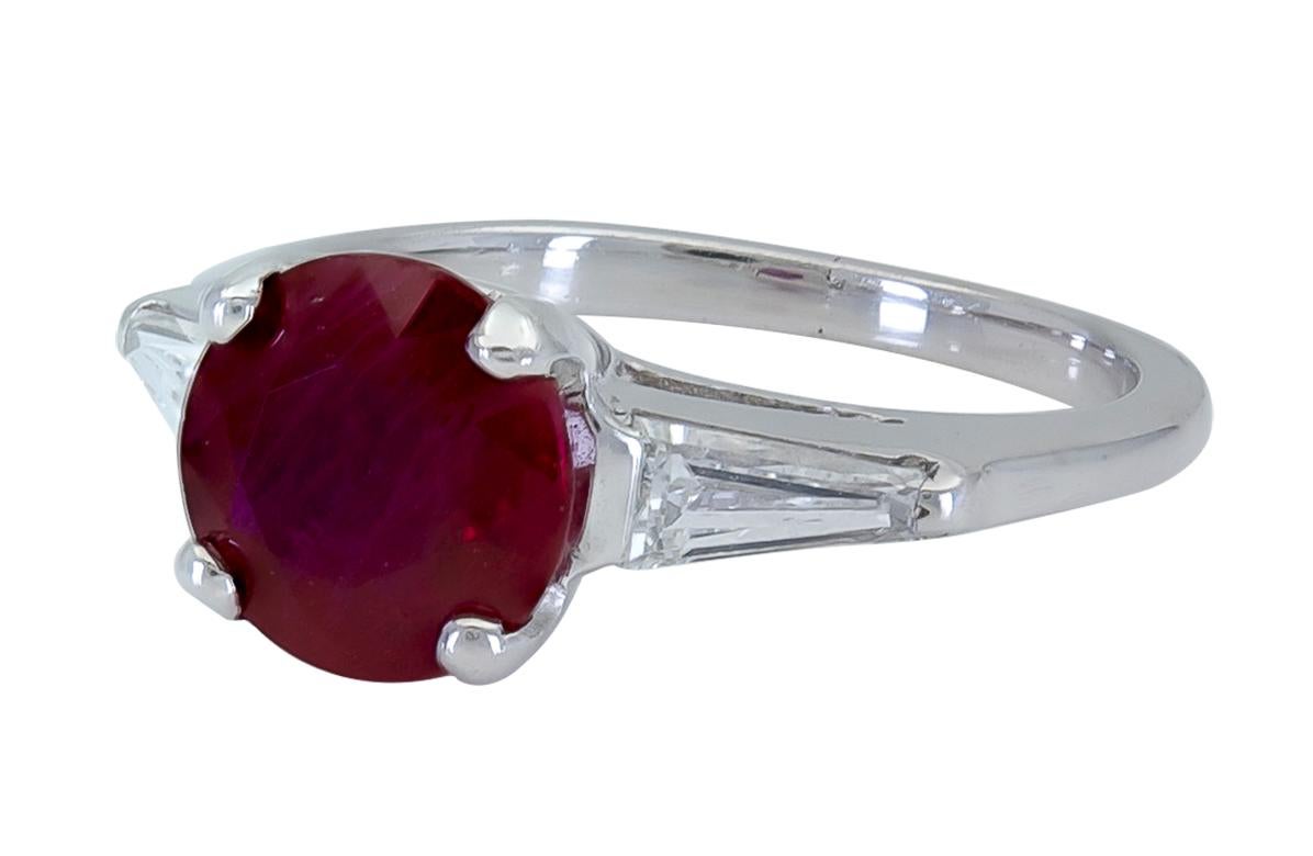 A timeless engagement ring style showcasing a round ruby flanked by tapered baguette diamonds on either side. Set in a polished mounting.
Ruby weighs 2.38 carats.
Side Diamonds weigh 0.40 carats total.
Size 5 US (sizable)
0.31 inches diameter (ruby)