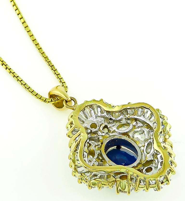 This stunning 18k yellow gold pendant is centered with a high quality cushion cut sapphire that weighs 2.38ct. The sapphire is accentuated by sparkling baguette, heart, marquise and round cut diamonds that weigh 2.11ct. graded G color with VS