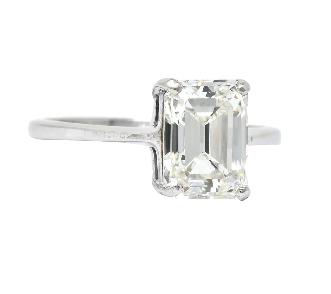 Centering an emerald cut diamond weighing 2.38 carats, J color and VS1 clarity

In a classic four prong basket setting

Stamped 90 Plat 10 Pall for platinum with palladium alloy

Ring Size: 6 1/4 & Sizable

Top measures 8.9 mm and sits 5.6 mm