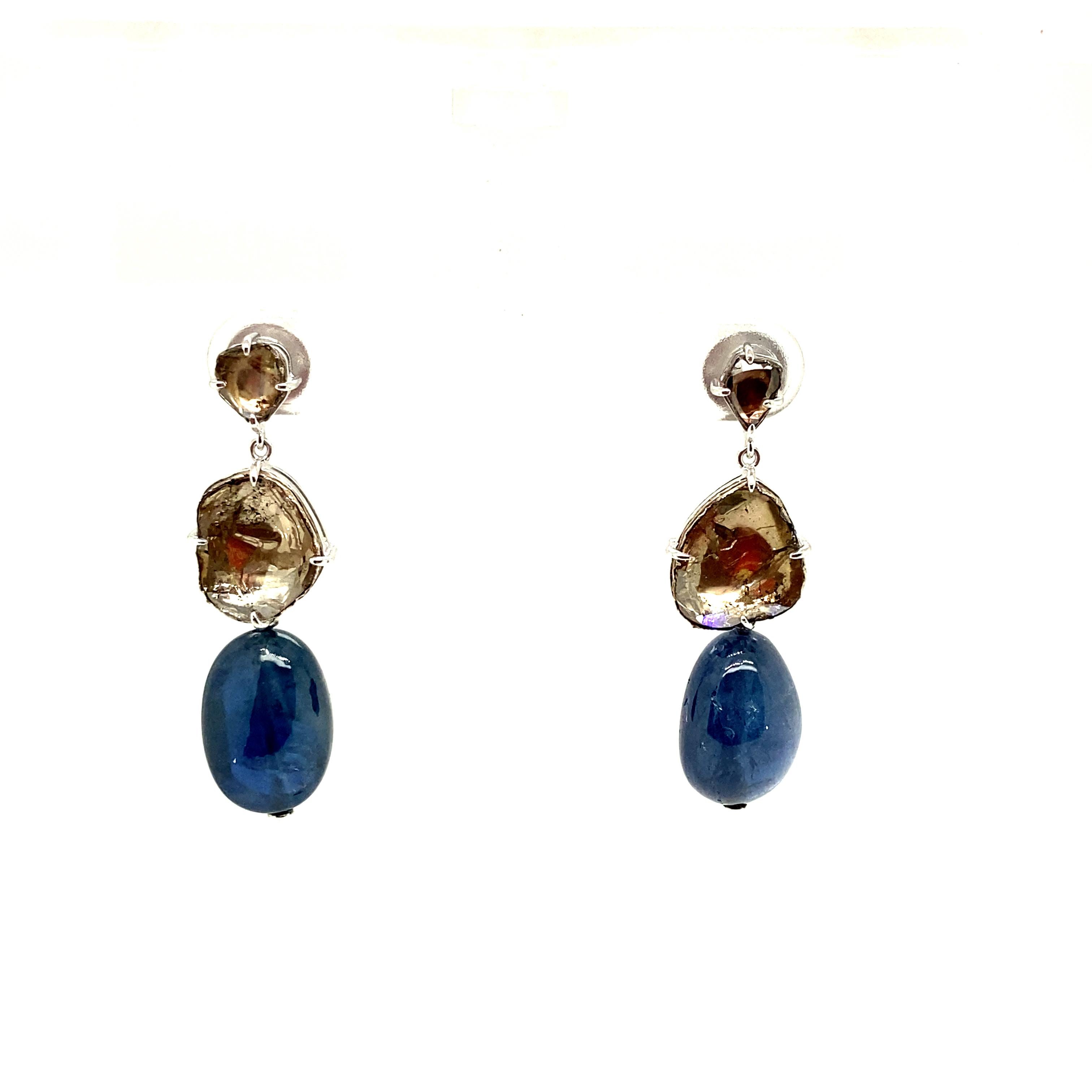 23.88 Carat Burma No Heat Sapphire Drops and Rose Cut Diamond Gold Earrings:

A beautiful pair of earrings, it features a pair of Burmese unheated blue sapphire drops weighing 23.88 carat topped by rose-cut diamonds weighing 4.21 carat. The sapphire