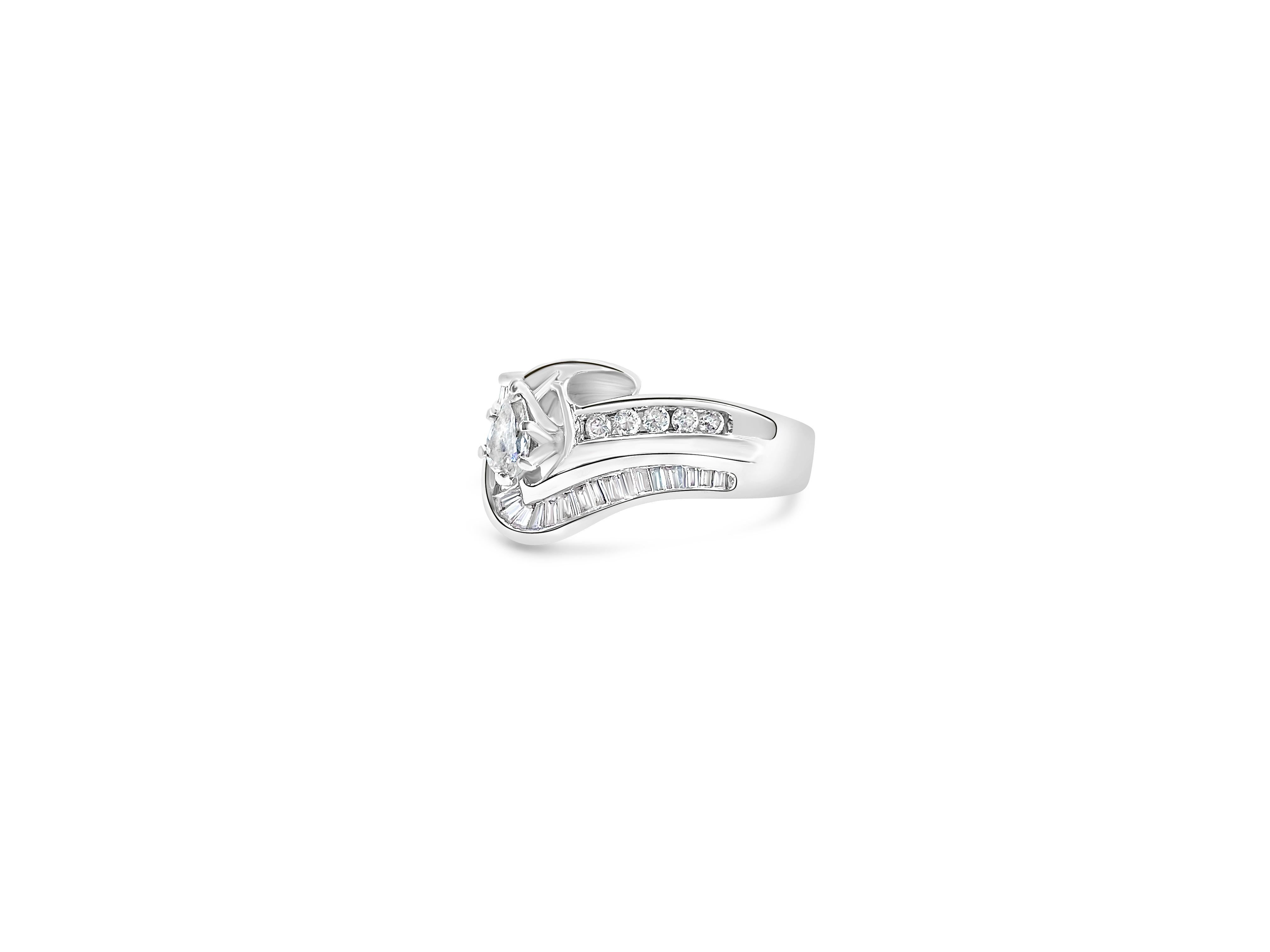 Crafted from 14k white gold, this elegant women's cluster diamond engagement ring showcases a total of 2.39 carats of round, pear, and baguette-cut diamonds. With SI1 clarity and G color, these natural earth-mined diamonds offer both brilliance and