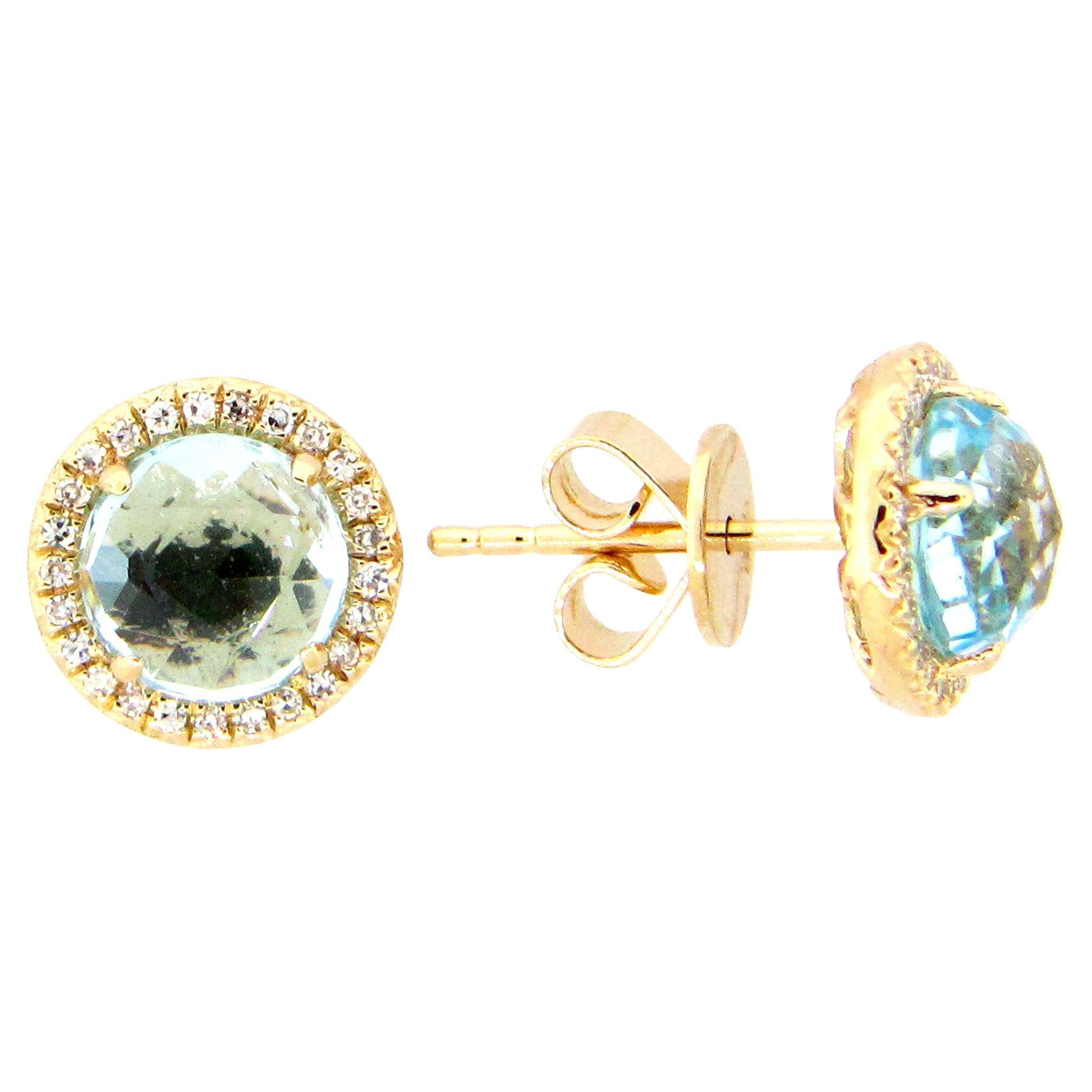 These Blue Topaz & Diamond Earrings are a stunning and timeless accessory that can add a touch of glamour and sophistication to any outfit. 

These earrings each feature a 1.20 Carat Round Blue Topaz, with a Diamond Halo comprised of 0.06 Carats of
