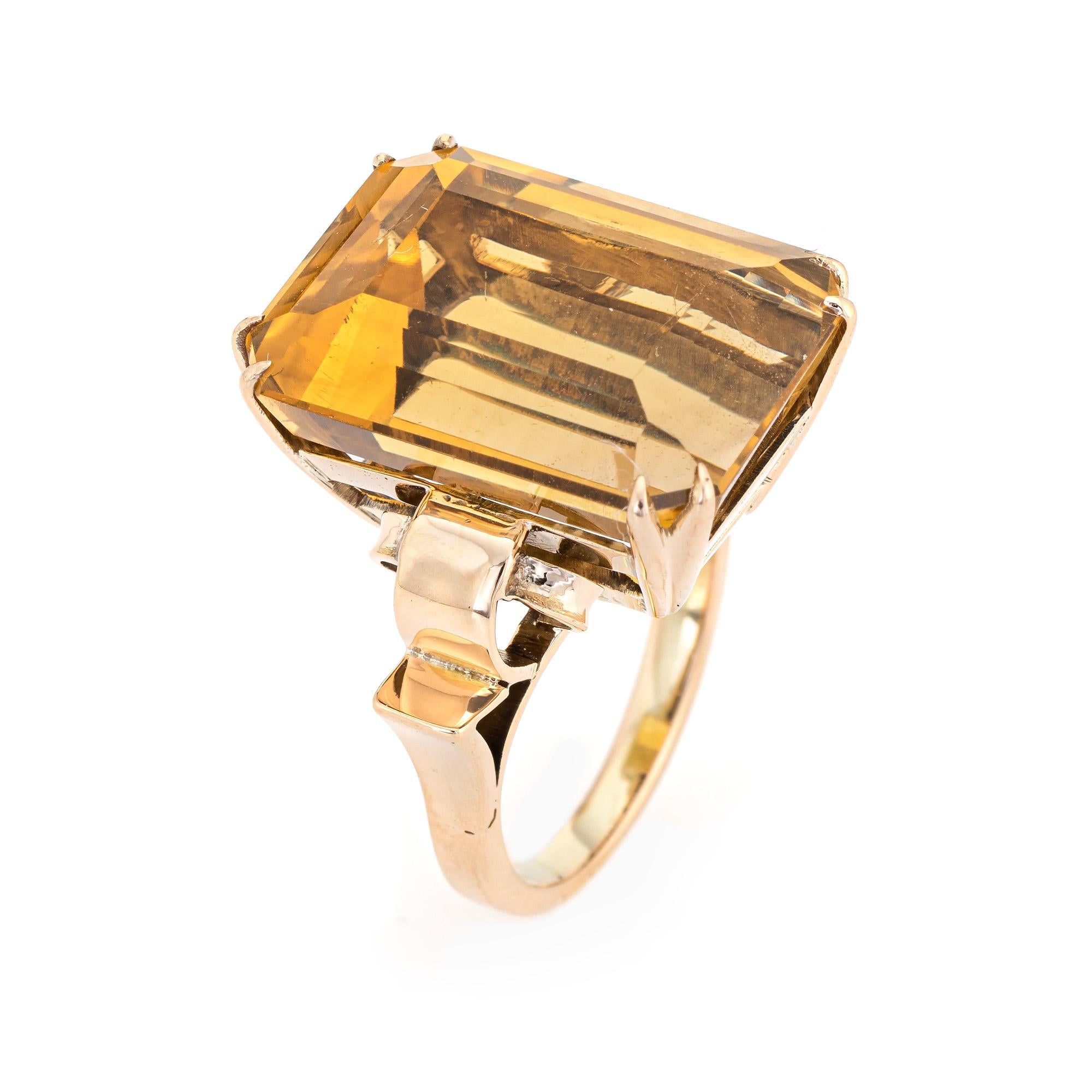 Stylish large estimated 23 carat citrine cocktail ring (circa 1940s to 1950s) crafted in 14 karat yellow gold. 

Emerald cut citrine measures 20mm x 15mm (estimated at 23 carats). The citrine is in very good condition and free of cracks or chips. 
