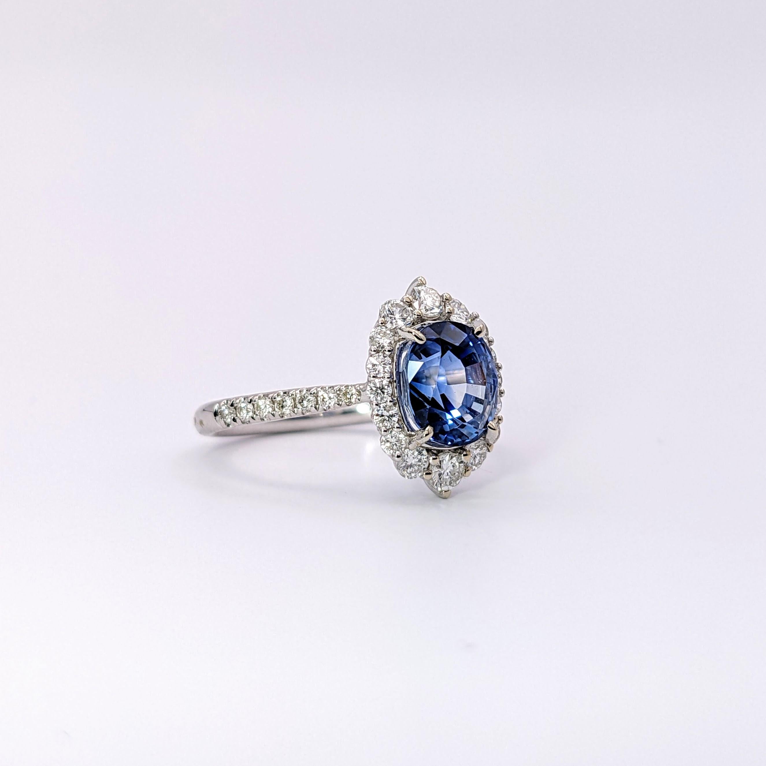 This lovely blue sapphire from Ceylon makes a beautiful ring in this setting of 14k solid white gold. A collection of different sized natural earth-mined round diamond accents make a sparkling oval-shaped halo and a pavé shank. The sapphire is said