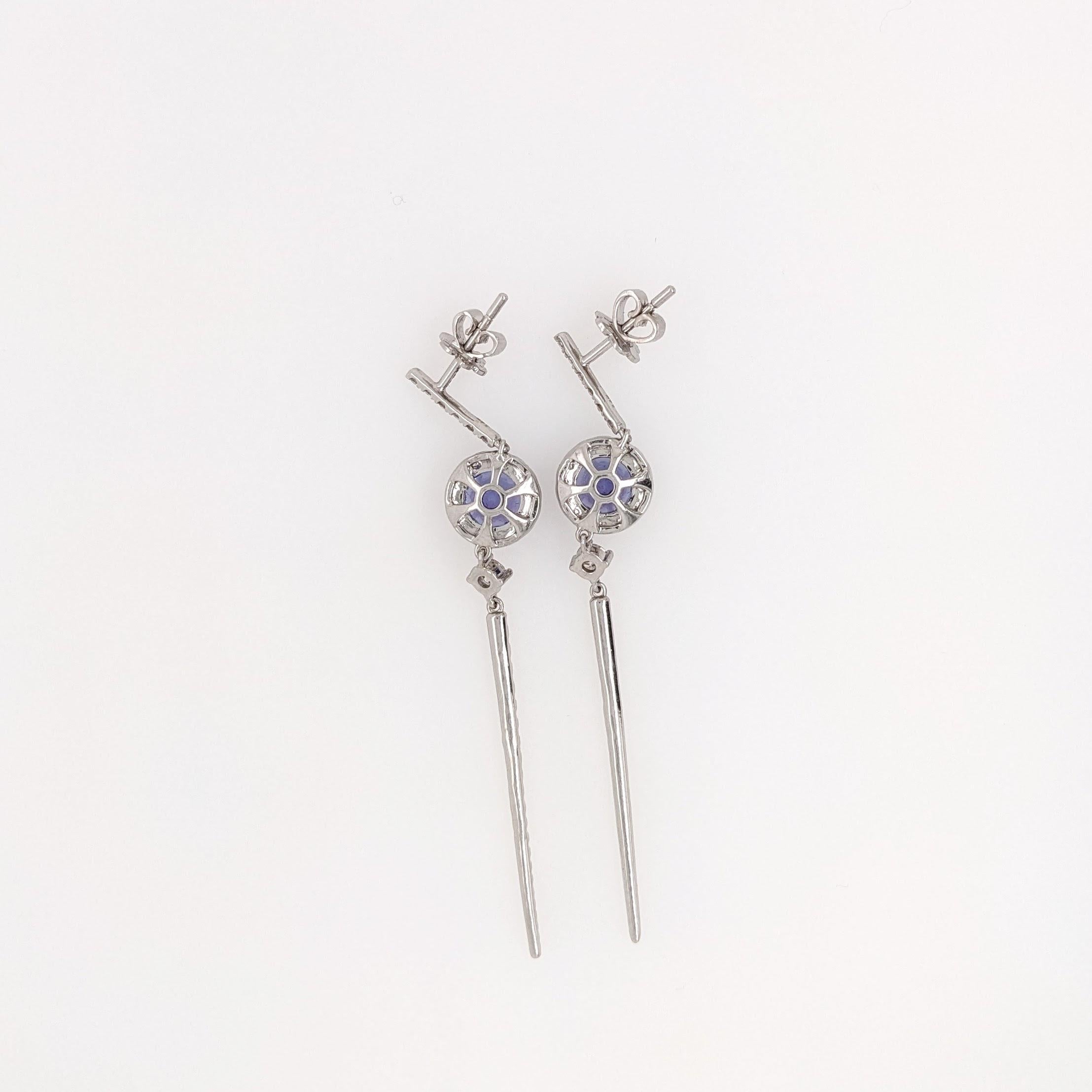 These gorgeous round tanzanite earrings are sure to catch the eye. With 34 natural, earth-mined diamond accents this piece is perfect for a wedding or any special occasion. These earrings are ready to ship as shown, or available to be customized