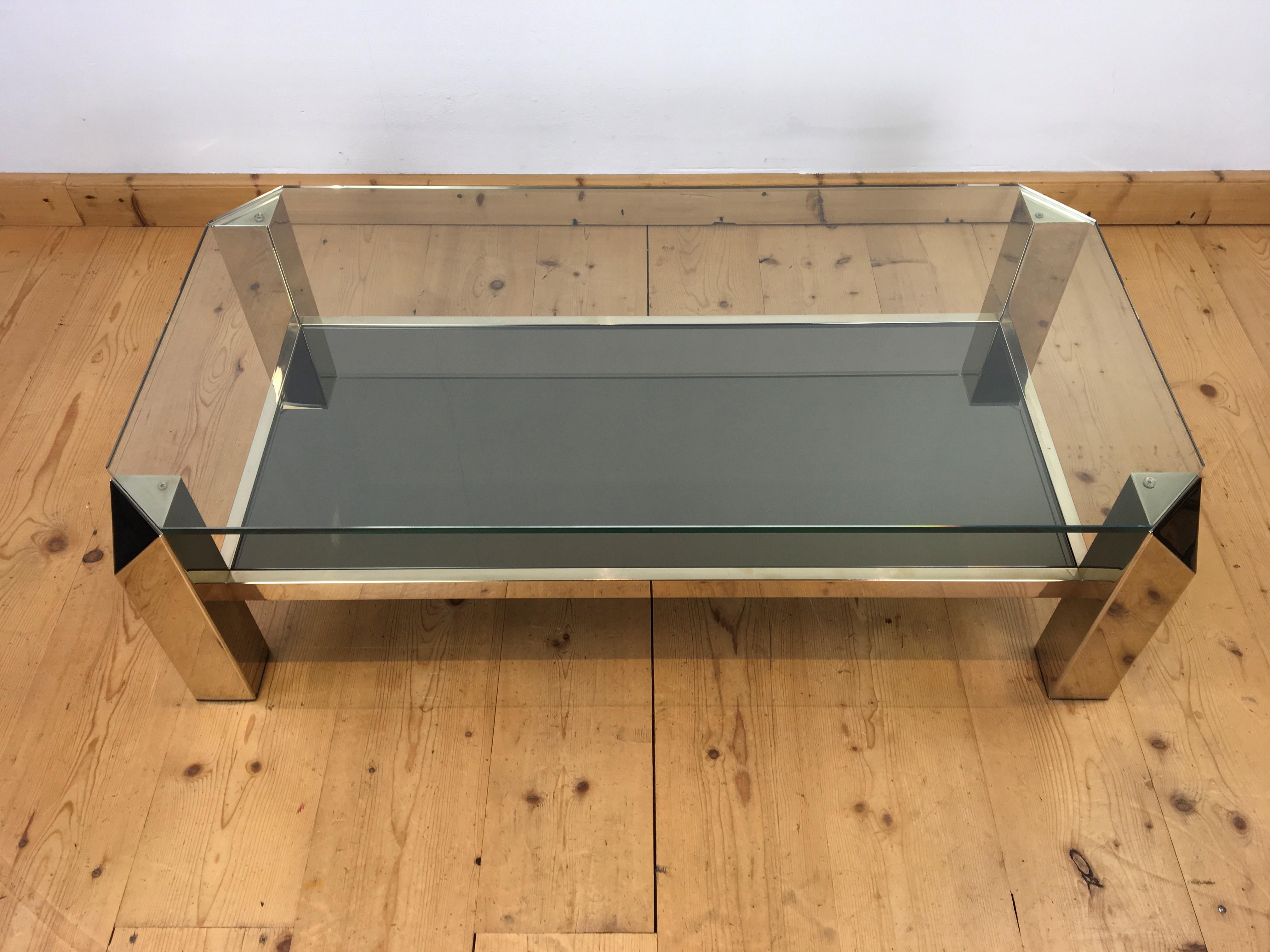 Great looking coffee table by Belgo Chrome - Dewulf selection.
A two tier coffee table with a 23kt gold plated - 23kt gilt base. 
The legs of this elongated - rectangular Belgo Chrom coffee table have a geometric design. 
This low coffee table