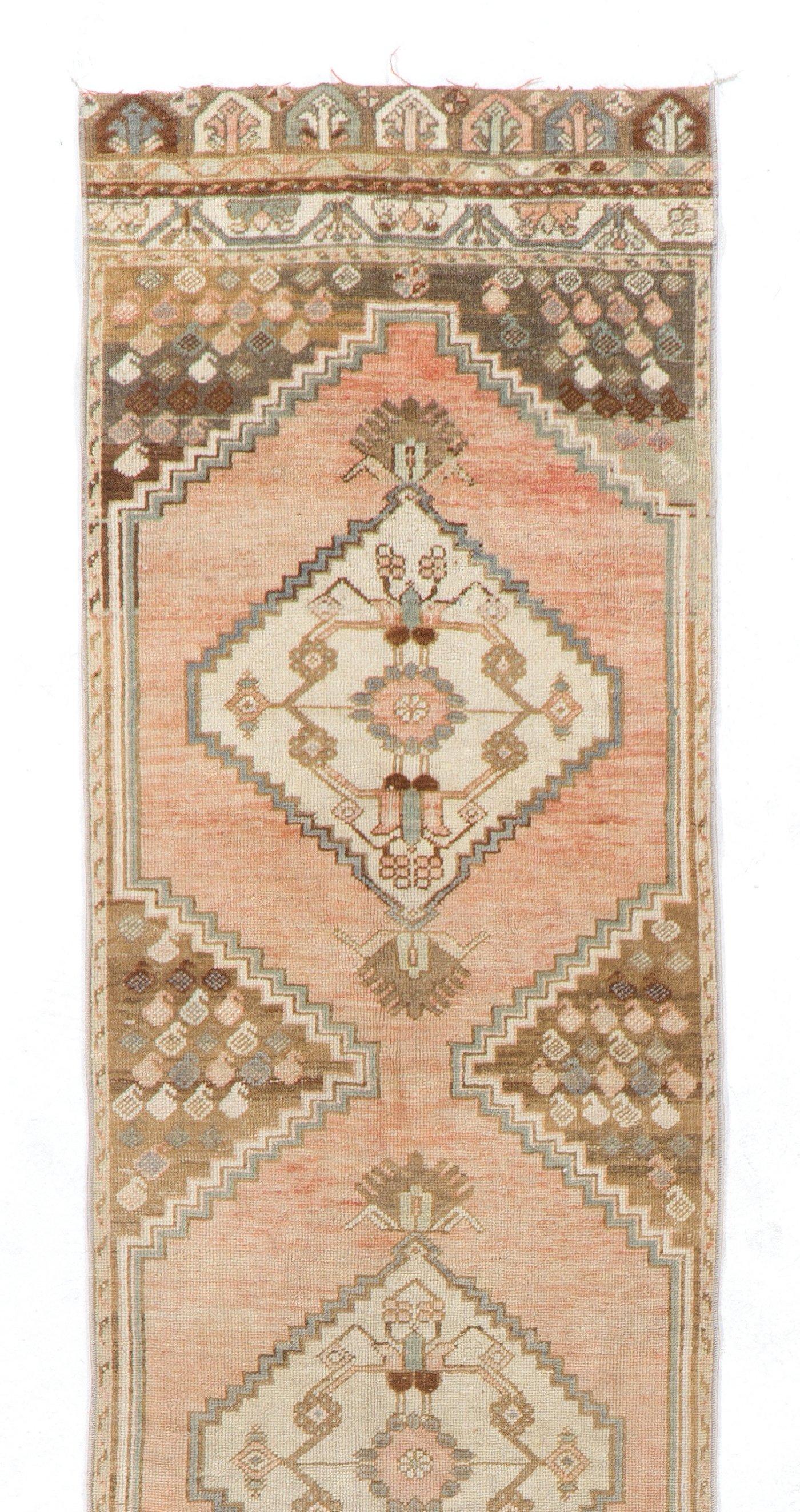 A vintage Turkish runner rug for hallway decor. It was hand-knotted in the 1960s with even medium wool pile on wool foundation and features a geometric design. It is in very good condition, professionally-washed, sturdy and suitable for areas with