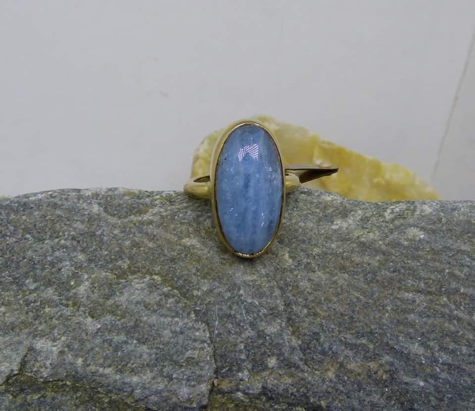 Elegant simplicity with a cabochon cut Aquamarine.  The Aquamarine is 23X12mm. The natural stone shows banded inclusions with a lovely pale blue colour.  The stone is bezel set in a handmade 9ct. gold ring.  The ring is hallmarked by the Dublin