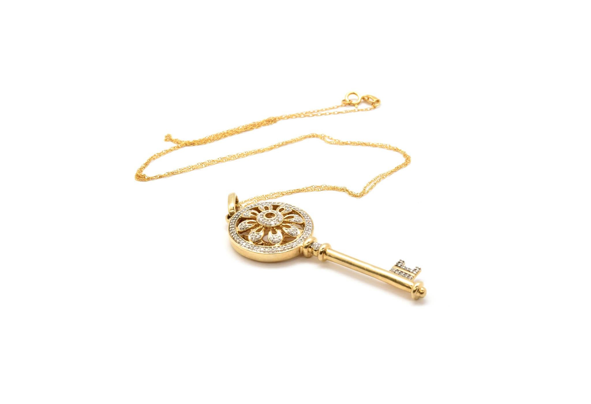 This necklace is made in solid 14k yellow gold bar links with a lobster clasp. The links measure 4.25mm wide, and the necklace measures 24 inches in length. It weighs 24.08 grams. The key pendant is made of 14k yellow gold and measures 2” inches