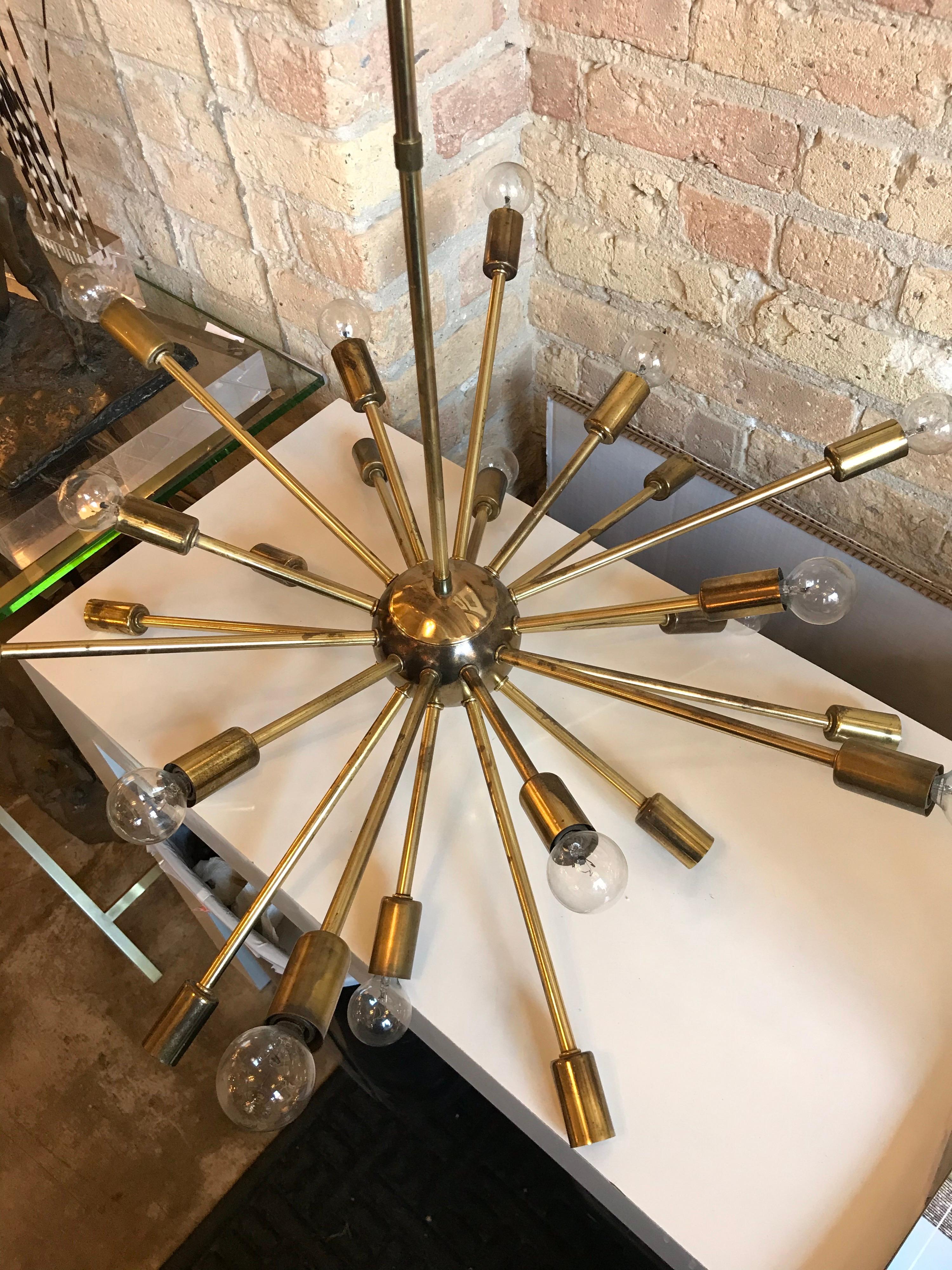 This is a vintage 24 arm brass Sputnik chandelier from the 1950s-1960s 
Has some tarnished areas but patina gives aged look. Has been required.