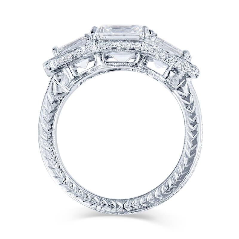 Exquisite lady’s engagement ring in 18KT white gold featuring 3 Asscher cut diamonds with the center stone weighing 2.40 carats (I color, VVS2 clarity), set in an antique style mounting that is detailed with beading and chasing along the edges and