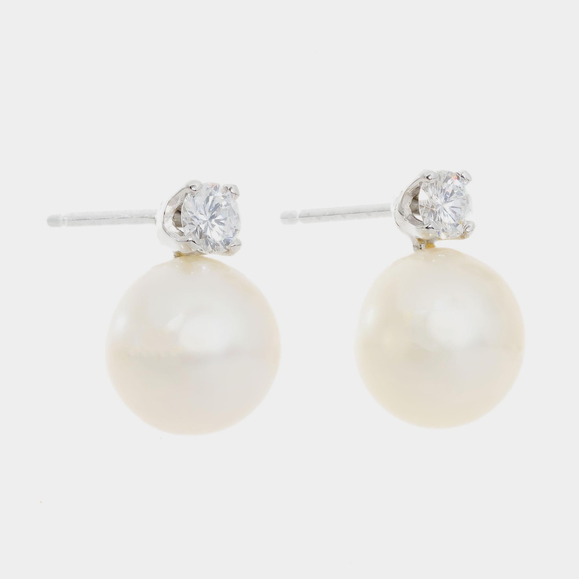 8mm Japanese Akoya cultured pearl and diamond earrings. 2 round brilliant cut diamonds with 2 round cultured 8mm pearls set in platinum. 

2 cultured white with crème hue pearls, few blemishes good lustre, 8mm
2 round brilliant cut diamond, G-H VS