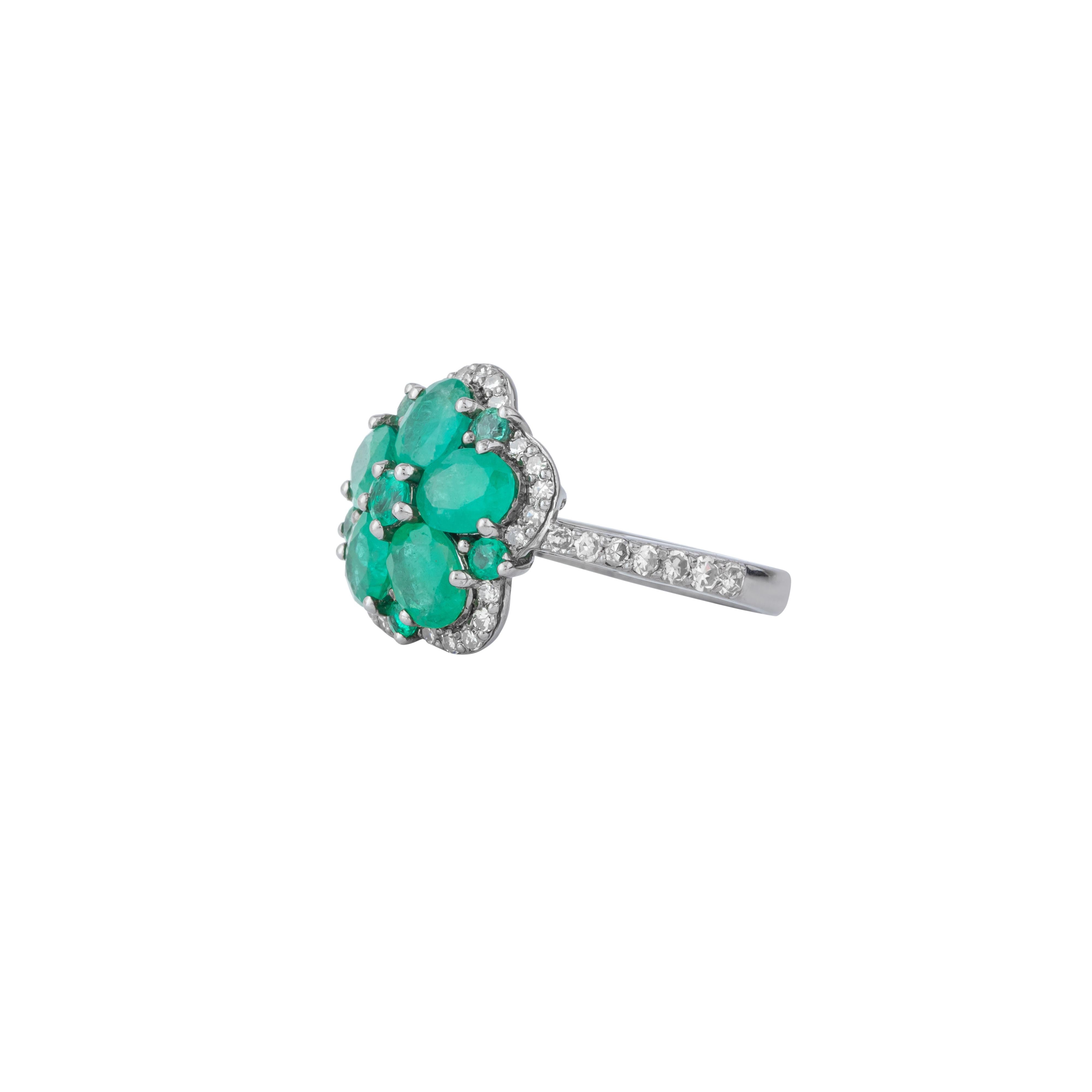 This 2.4 Carat Diamond and Emerald Flower Ring is a masterpiece of sophisticated design, blending timeless elegance with contemporary flair. The ring features a striking floral motif, where vibrant emeralds and dazzling diamonds converge in a