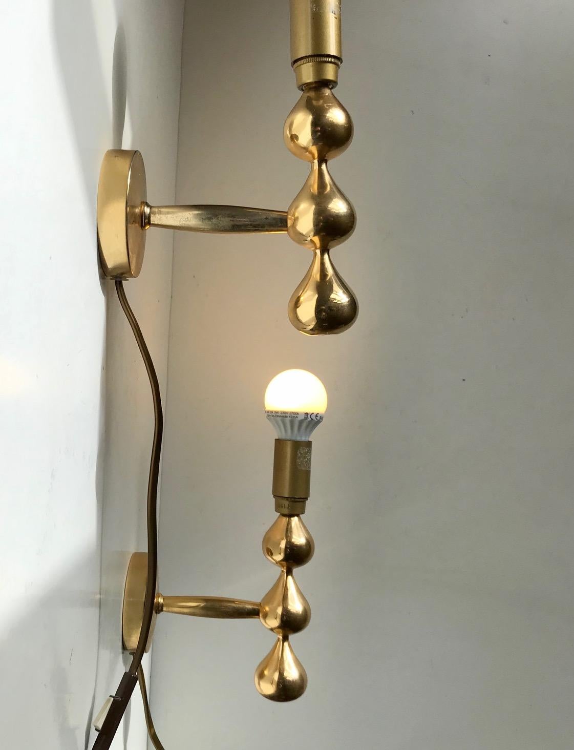 Sculptural tear drop shaped set of 24-carat gold plated Wall lights designed by Hugo Asmussen for Asmussen in Denmark, circa 1960-70. Very heavy made stock in a superb quality. Use them as depicted with a decorative dim bulb or personalize with a
