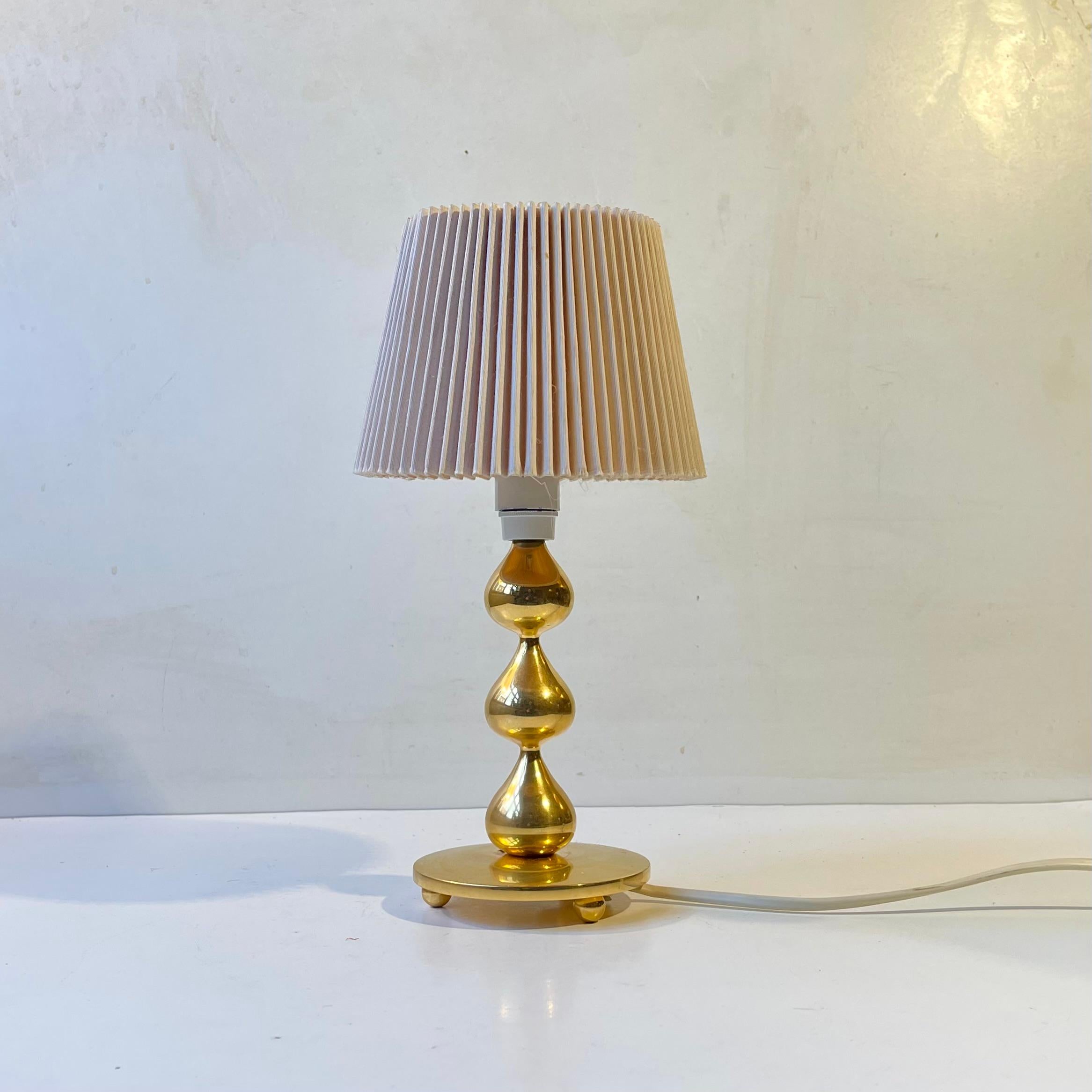 Sculptural tear drop shaped 24-carat gold plated small Table light designed by Hugo Asmussen for Asmussen in Denmark, circa 1960-70. Very heavy made stock in a superb quality. It comes with a fluted 1970s Danish shade. Suitable for modern,