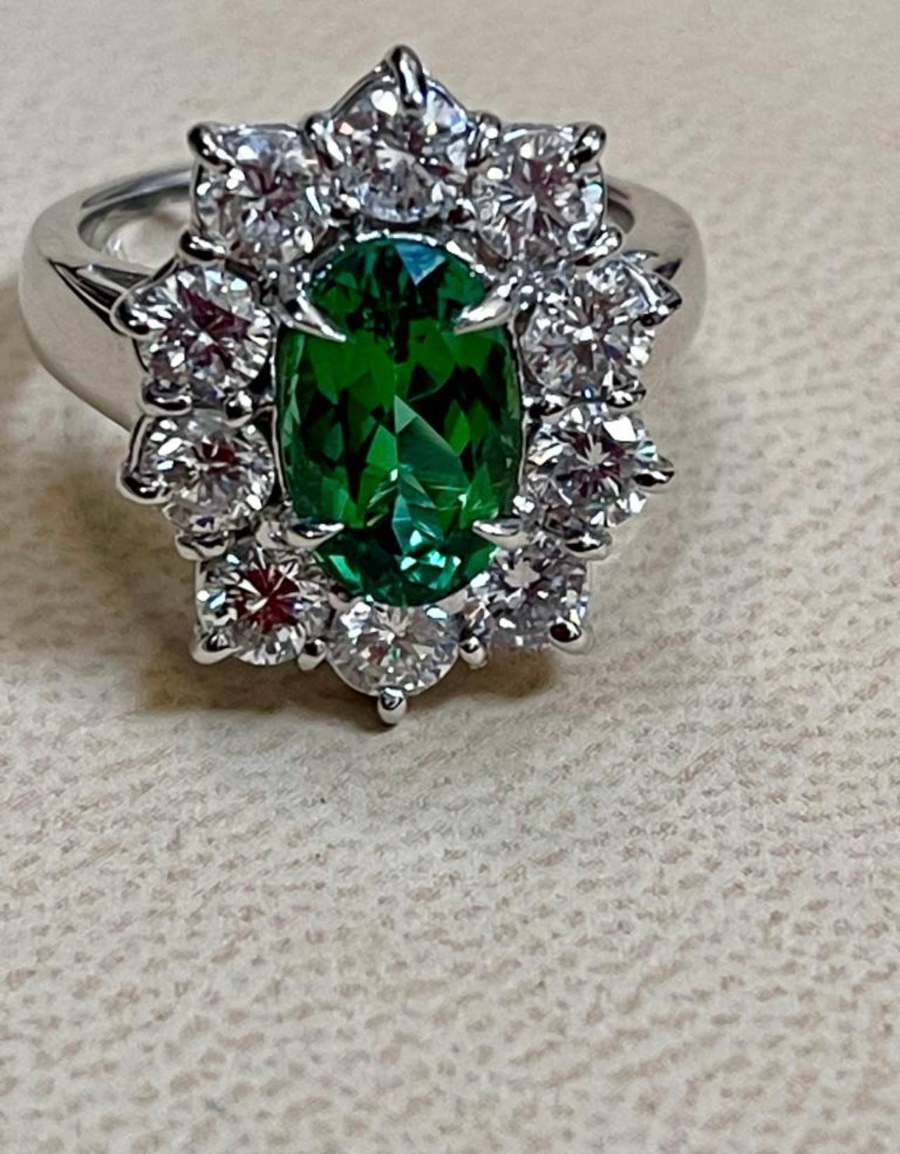 2.4 Carat Oval Tsavorite and 2 Carat Diamond in 18 Karat White Gold Ring Estate Size 6
Tsavorite of this color and size are very precious!
Approximately 2.4 Carat  long Oval cut Tsavorite and Diamond Ring, Estate with no color enhancement.
Gold: 18