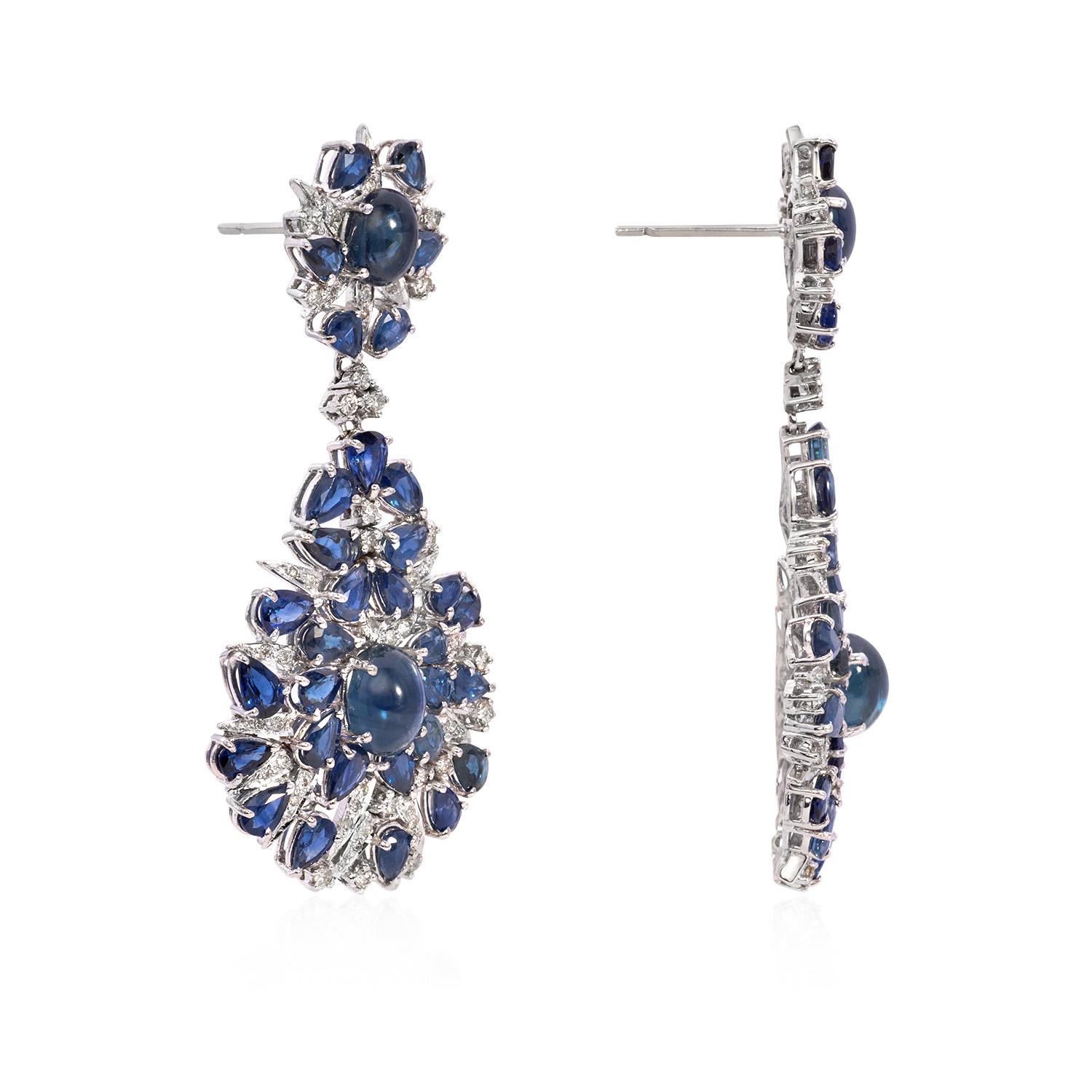 Introducing our exquisite Blue Sapphire and Diamond Drop Earrings with Cabs, a stunning pair of earrings that combines the timeless allure of natural blue sapphires with the brilliance of diamonds, all elegantly set in luxurious 18K gold weighing