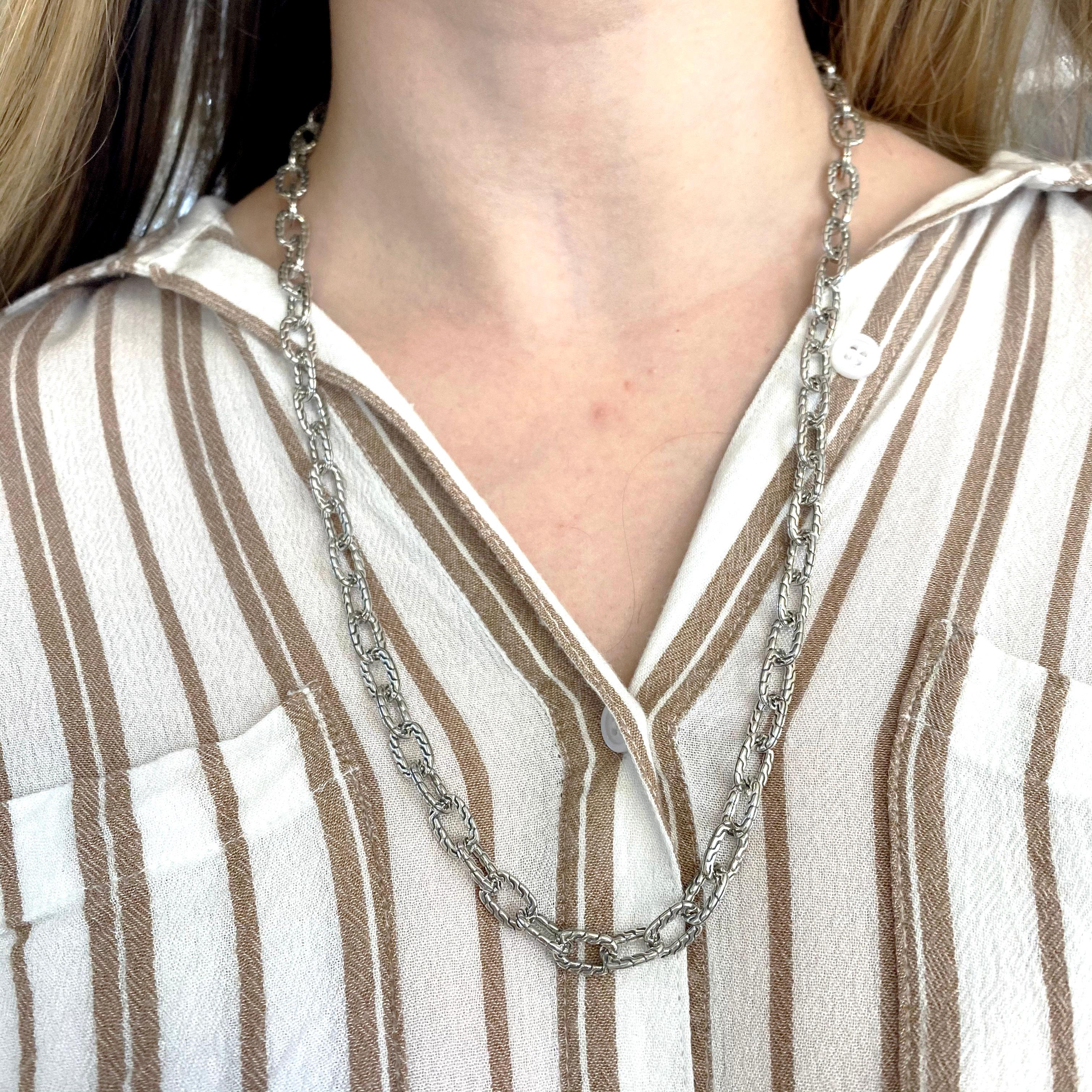 This heavy designer chain in made in solid sterling silver and weighs almost 2 ounces and is 24 inches long.  This length is perfect for putting over your head and not worrying about the clasp. The links are 8.25 millimeter in diameter and make a