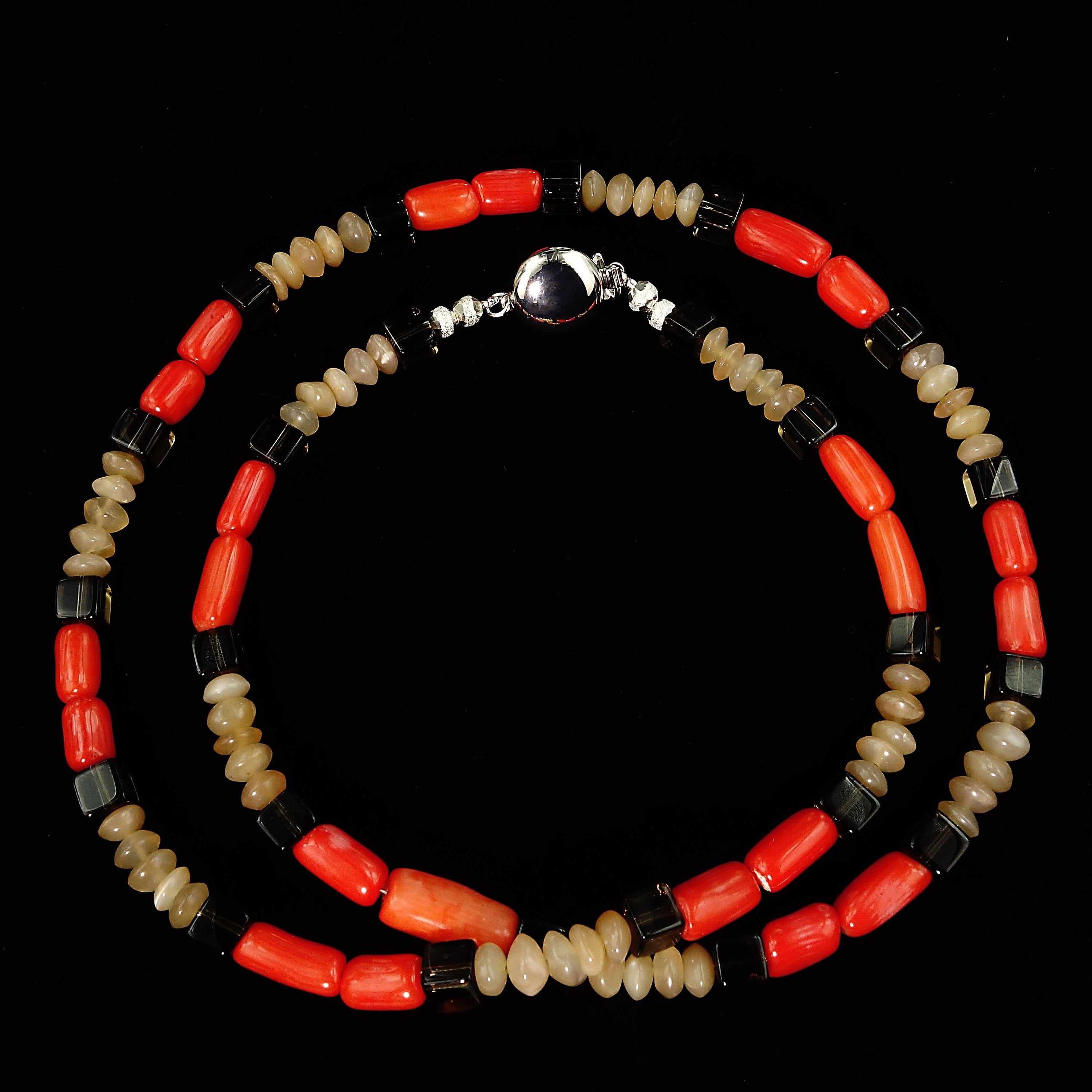 Delightful, handmade necklace of highly polished bright orange Coral tubes, rondelles of Sunstone, and squares of transparent Smoky Quartz. Smoky Quartz is a variant of the Quartz mineral family which ranges in color from a light gray to darker