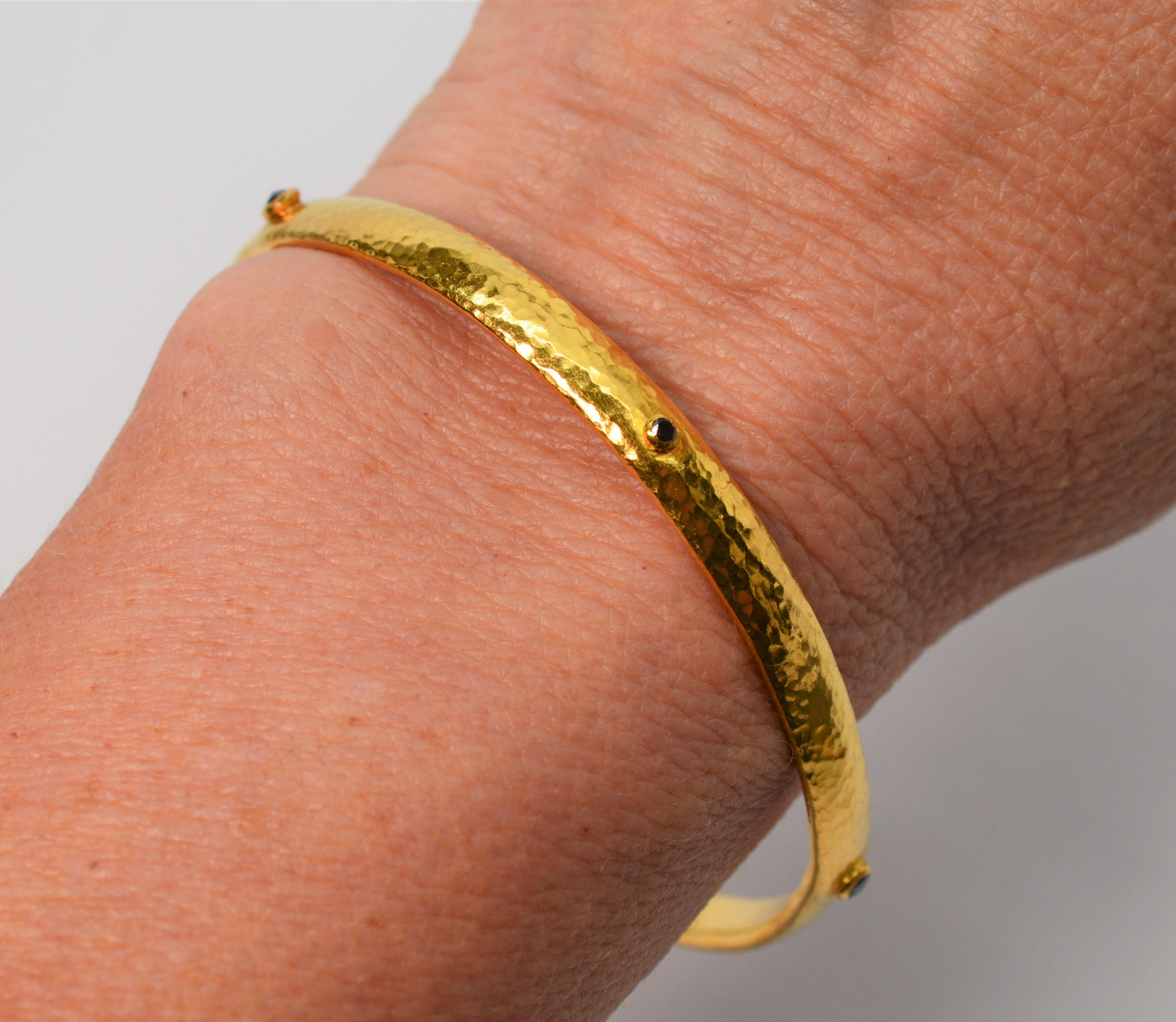 Slender artisan yellow gold bangle bracelet with five faceted sapphire accents by internationally known, Gurhan Atelier. Each piece is hand crafted by specially trained master artisans in the Gurhan Istanbul workshops. Expertly hand hammered lost