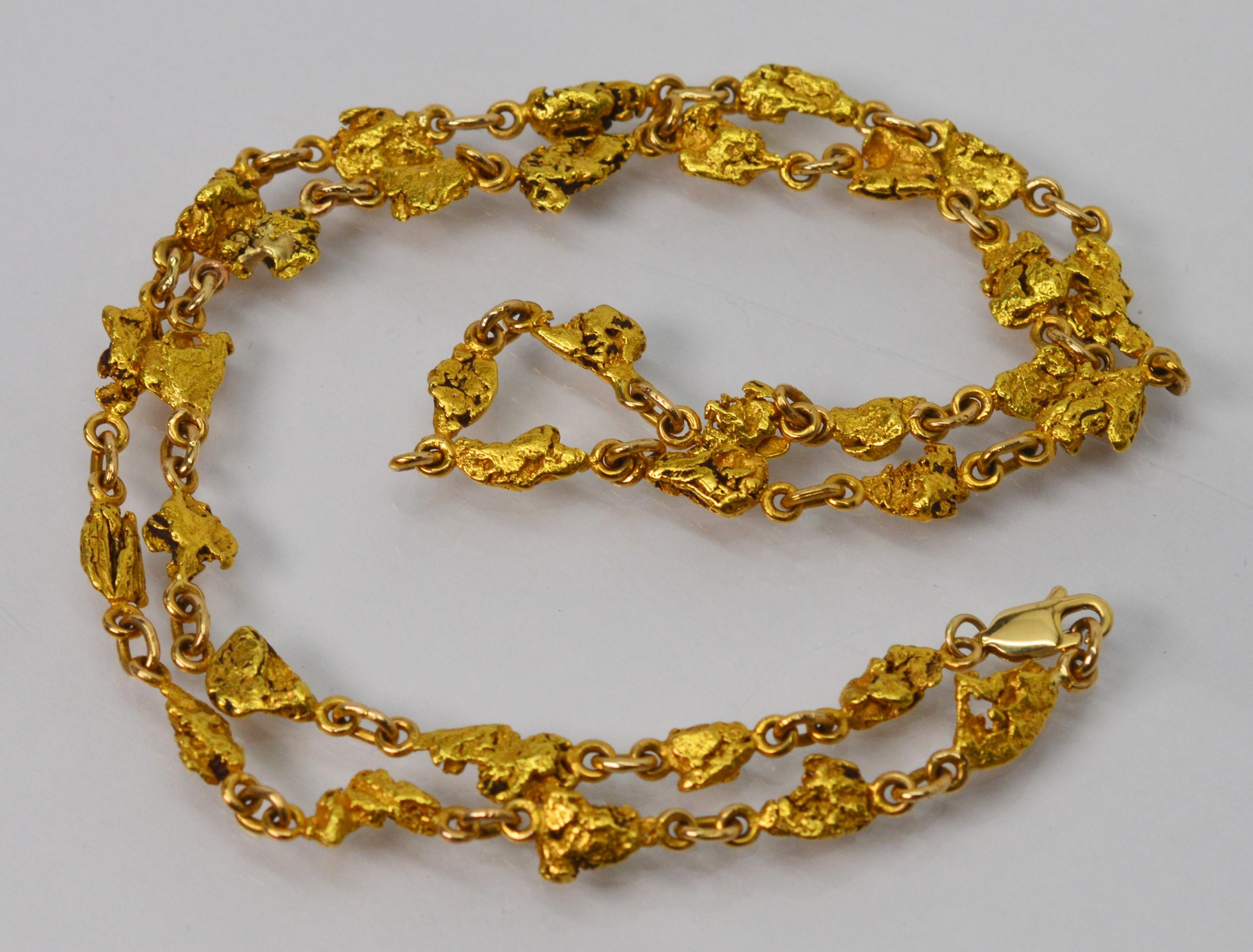 Intriguing twenty four 24 karat natural yellow gold nugget twenty inch (20 inch) chain necklace.
Each of the 35 natural placer nuggets were recovered from panning in water and are uniquely shaped and linked to create a bright, fluid and interesting