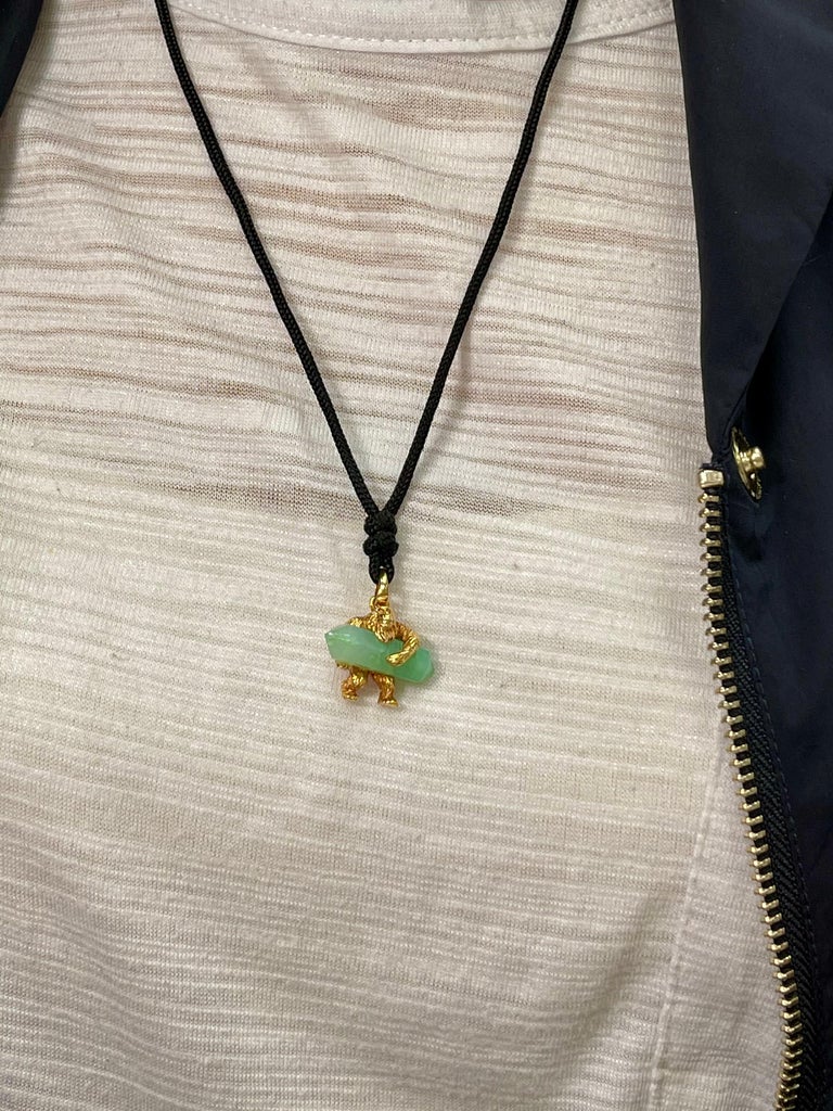 Here is something you won't see everyday. This 24k pure yellow gold and green crystal pendant is so unique. A conversation starter for sure. The pure gold gorilla is holding a nice green crystal. The crystal has nice undamaged tips. Its not easy to