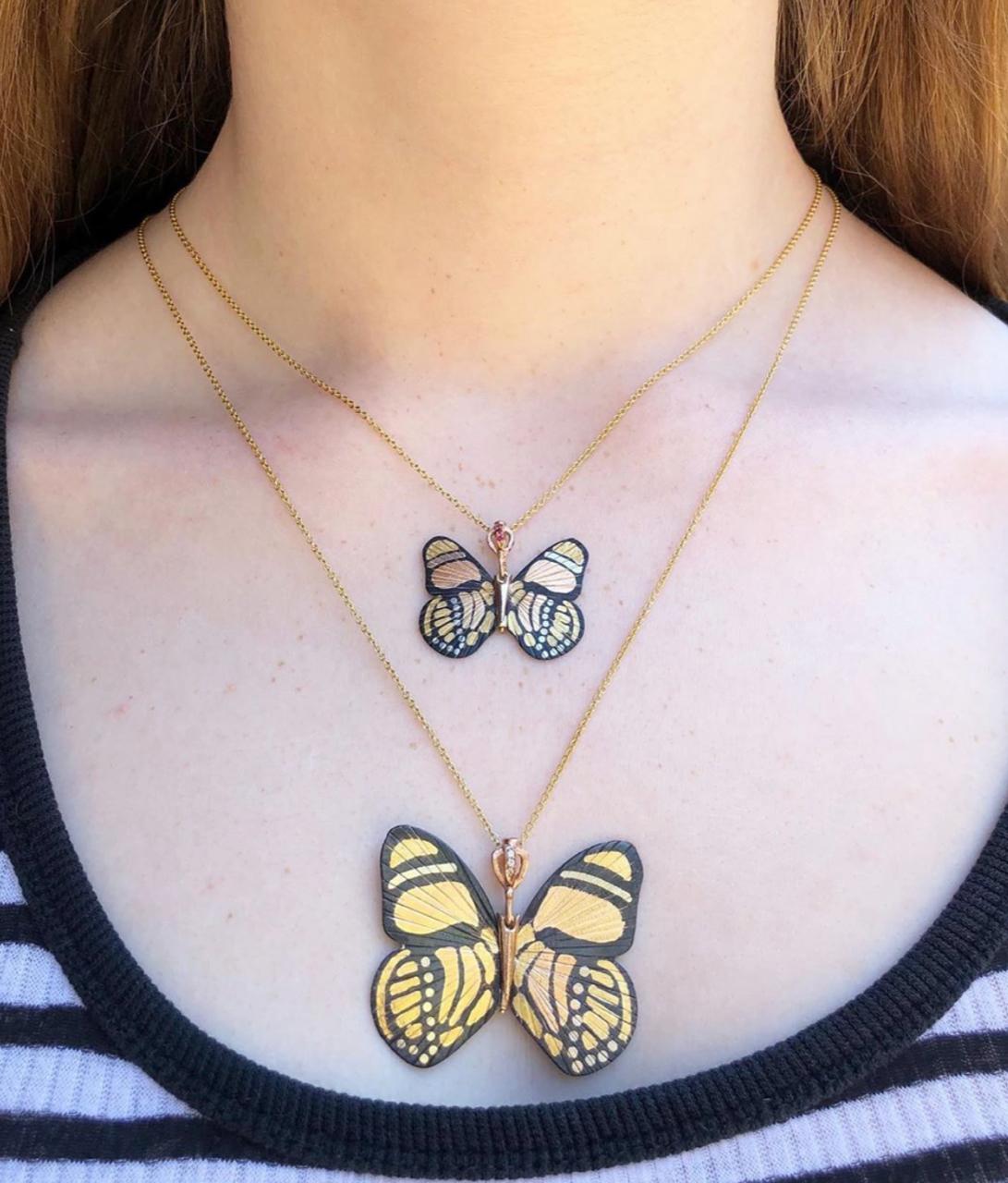 James Banks's signature butterfly necklace features a Baby version of the Callicore Butterfly with a hinge at the center to allow movement of the wings, set in 24k Yellow Gold with 18k White Gold inlay and Shakudo, with Rubies set in the hook, and