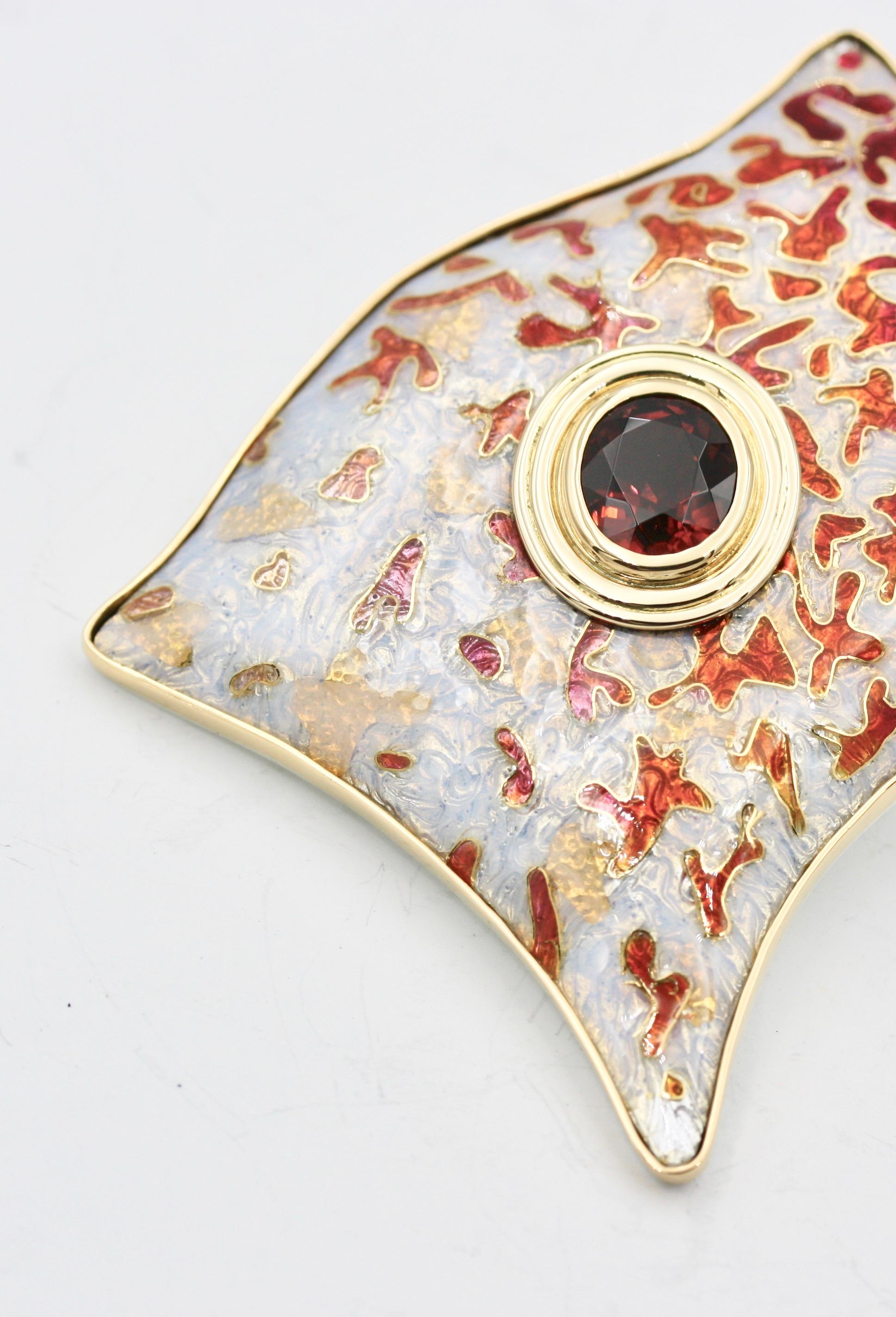 This hand made cloisonné enamel brooch is called INFATUTION. It is set in 22 Karat Yellow Gold with a 7.6 carat Tourmaline, 12.02 x 10.4 x 8.2mm. The red colours slowly shading to pale pink surrounded by pale opalescence. The enamel is inlaid with 