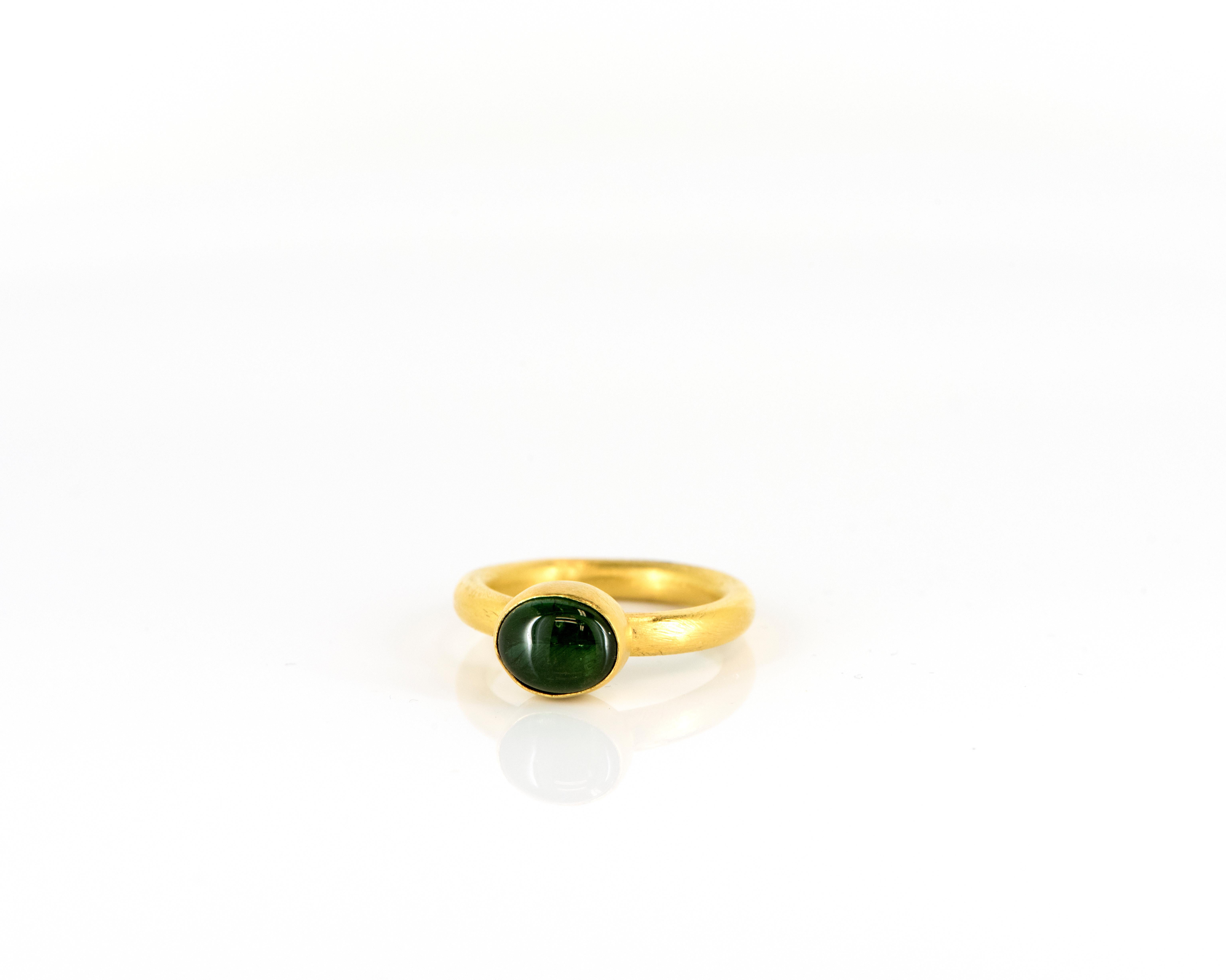 Featuring the natural beauty of Tourmaline, these 24 Karat Yellow Gold Stackable Rings are the perfect addition to any jewelry collection. The rich green and pink hues of the Tourmaline gemstones complement each other perfectly, adding a pop of