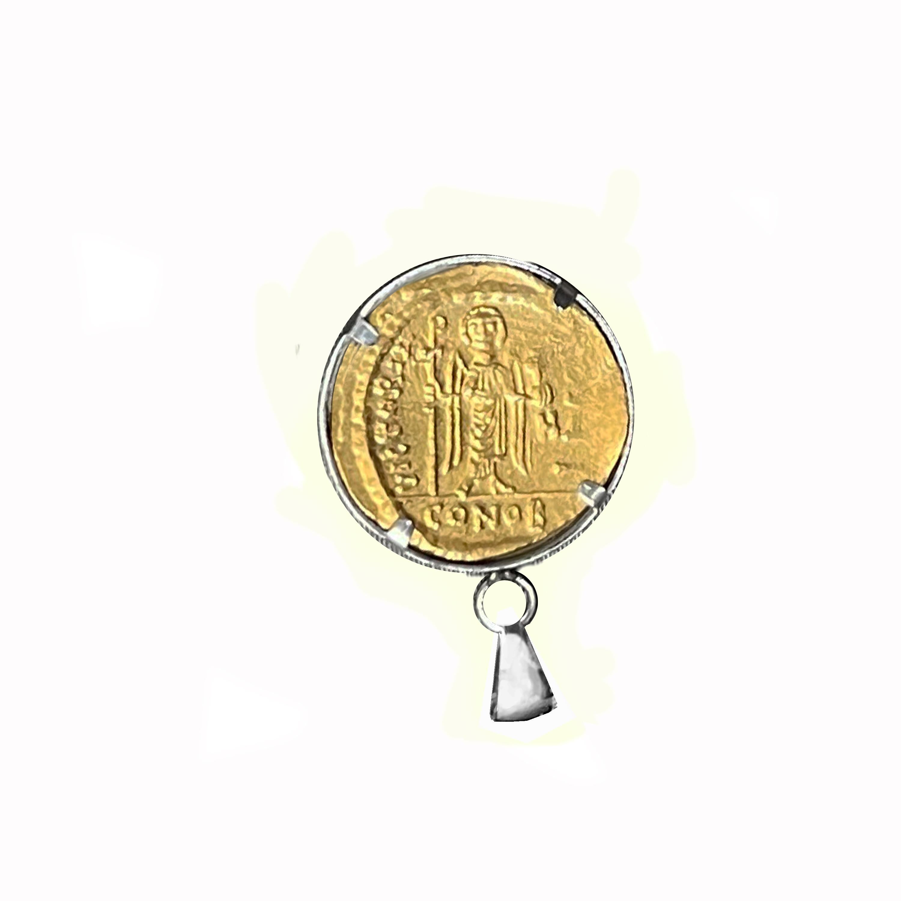  In this sterling silver pendant is set an authentic 24 Kt pure gold Byzantine coin depicting the Emperor Phocas.
Flavius Phocas ( 547 – 5 October 610) was Eastern Roman emperor from 602 to 610. The early life of Phocas is largely unknown, but he