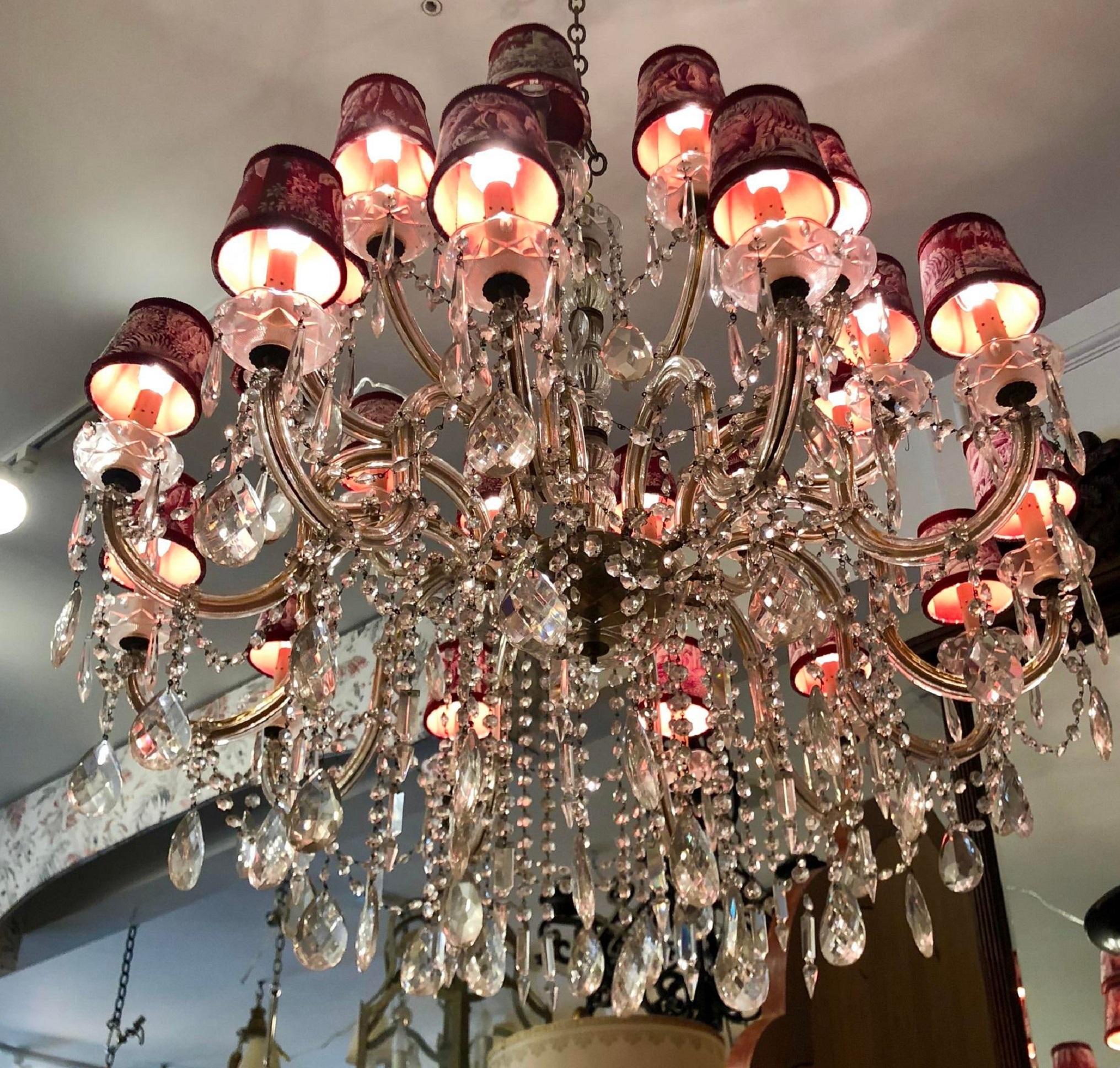 24 light French crystal chandelier with Manuel Canovas toile shades.