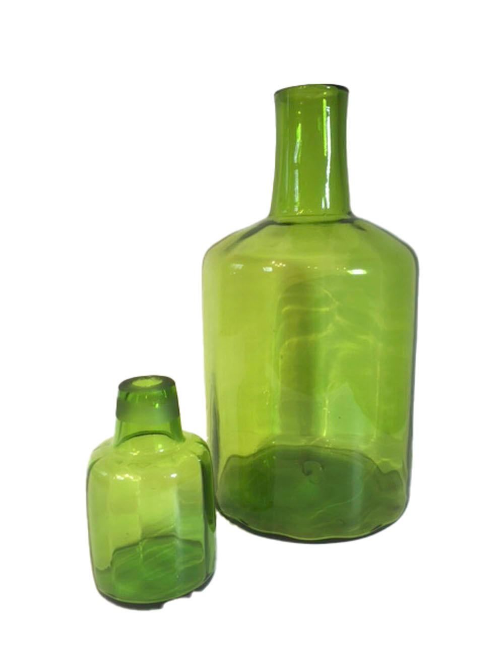 Large Mid-Century Modern floor vase by Blenko Glass in the form of an oversized decanter and stopper. The hand blown vivid green glass with optical ribbing and broken pontil. Measures: 24