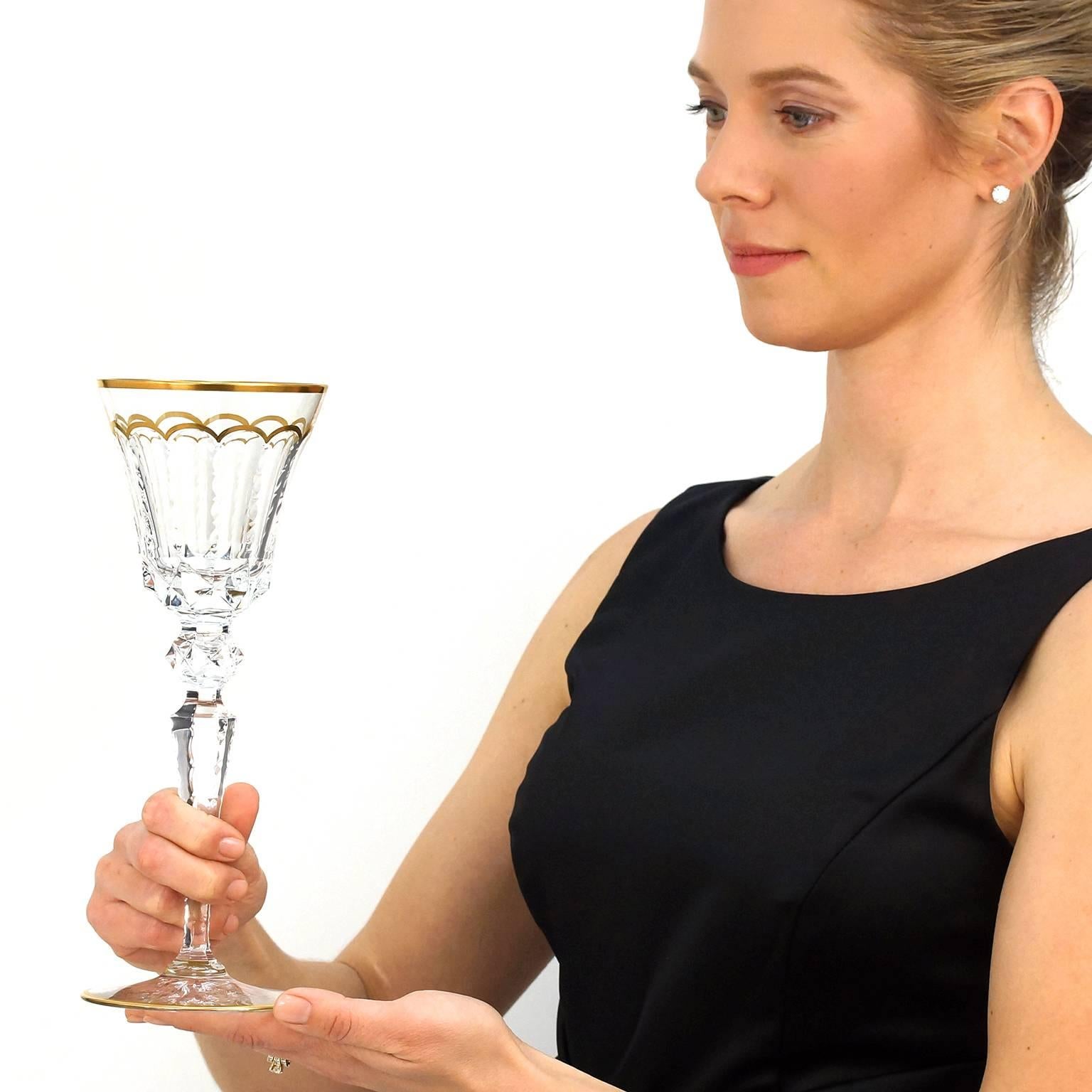 Circa 1967, St. Louis Crystal, France. Magnificently tall, these stunning St. Louis water goblets in the renowned “Excellence” pattern feature a detailed hand-cut pattern, gold trim, and impressive height (over ten inches). Setting a memorable
