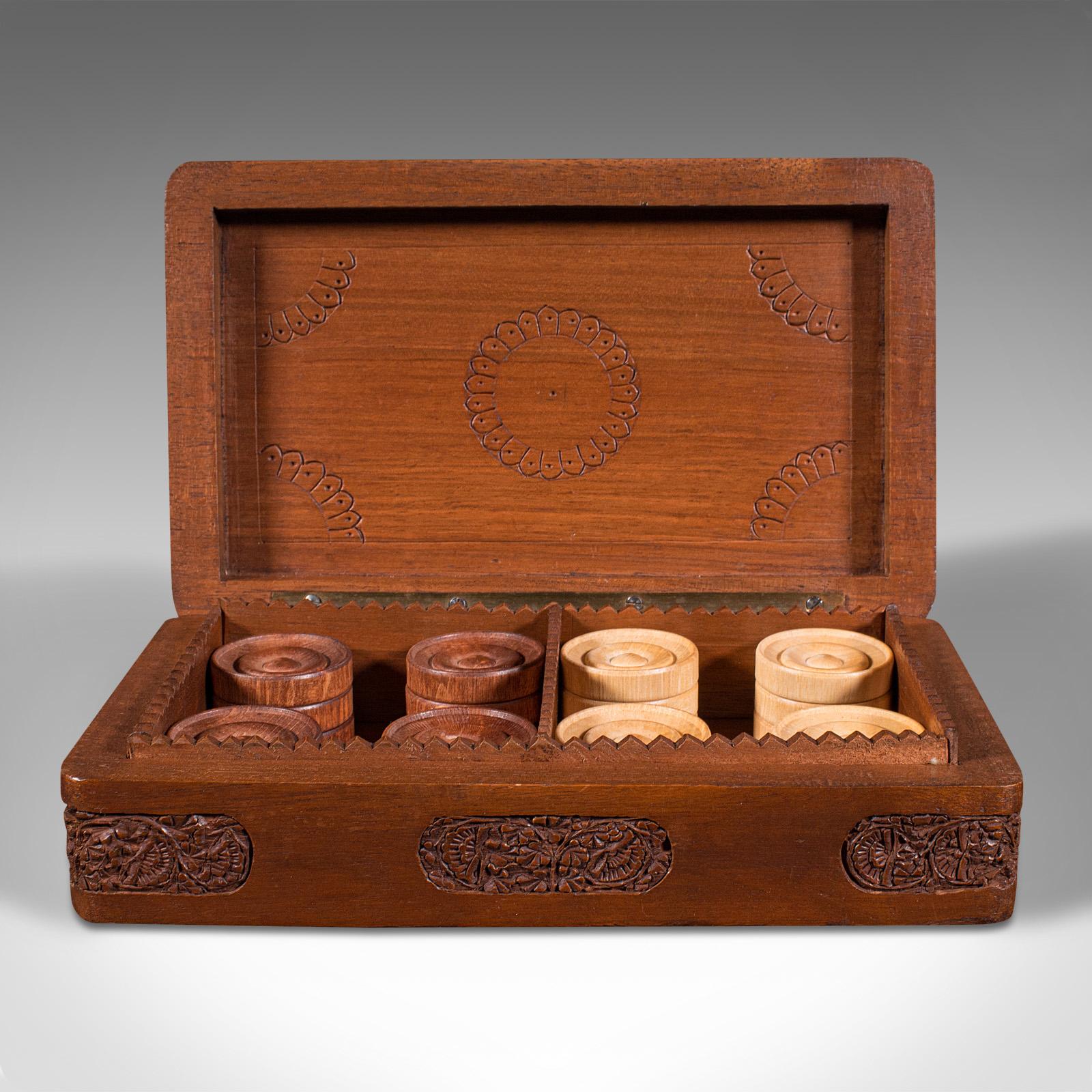 This is a set of vintage gentleman's club draughts pieces. An Oriental, mahogany game counter and carry case, dating to the late Art Deco period, circa 1940.

Pleasingly presented set of 24 draughts game pieces
Displays a desirable aged patina