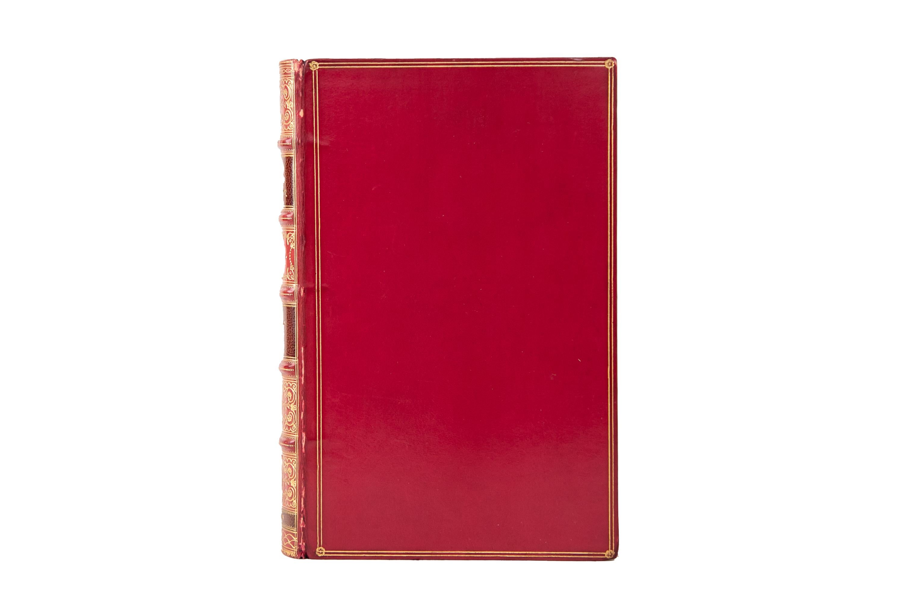 24 Volumes. George Eliot, The Works. Cabinet Edition. Bound by Tout in full red calf with a gilt-tooled border on the covers. Raised band spines with ornate gilt-tooled details, brown morocco labels, and a green morocco circle displaying the volume