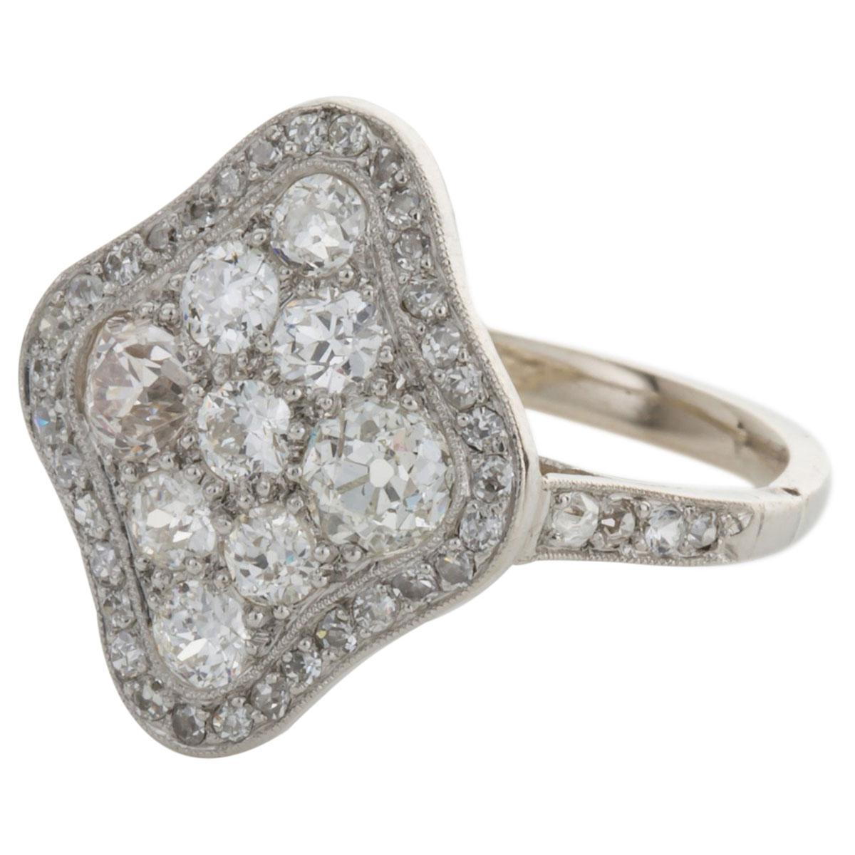 A lovely sparkling shield shape of diamonds that sit beautifully in this pretty ring. There are 9 larger diamonds that form the triangular central section that are surrounded with a border of smaller diamonds in a millegrain setting. The shoulders